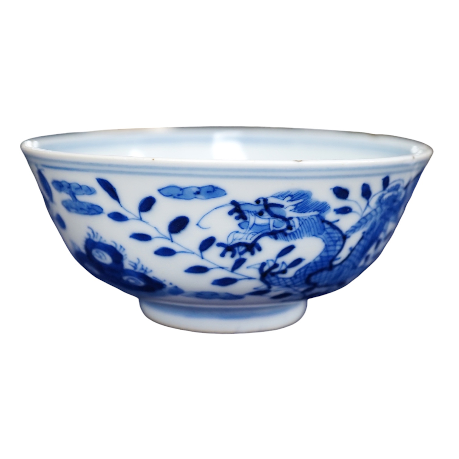 A Chinese blue and white ‘dragon’ bowl, Qianlong mark but 19th century, 12.5cm diameter. Condition - overglazed imperfection                                                                                                