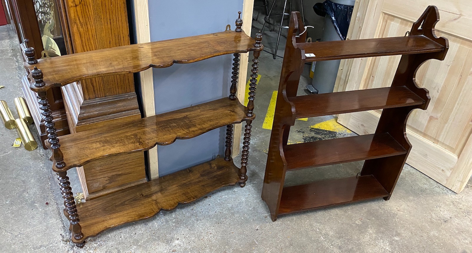 A Victorian walnut serpentine three tier wall bracket width 80cms, height 89cms and a later Victorian mahogany four tier wall bracket.                                                                                      