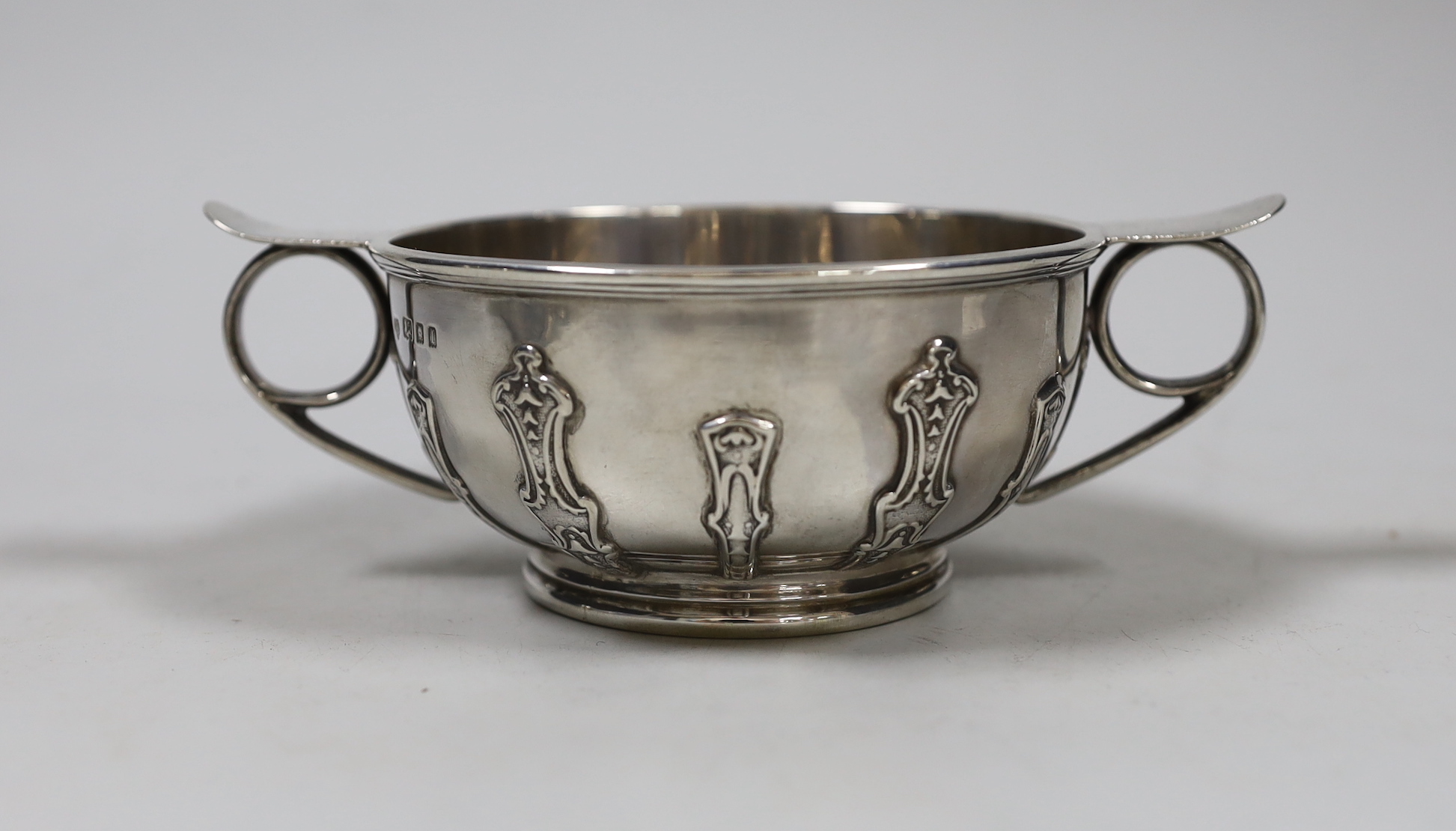 A George V silver two handled bowl, with cut card decoration, Goldsmiths & Silversmiths Co Ltd London, 1926. diameter 16.3cm over handles, 8.4oz.                                                                           