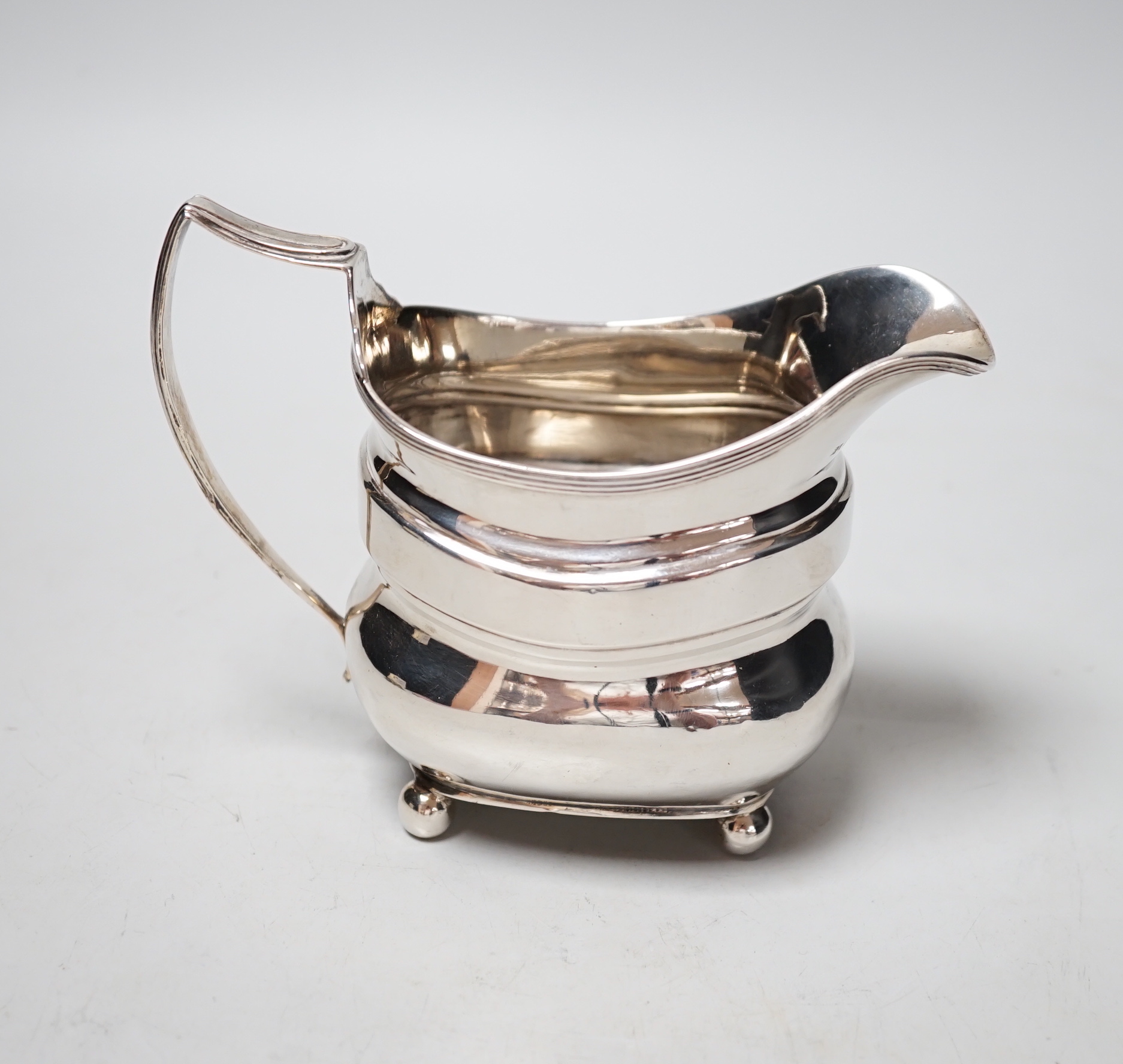 A George III silver cream jug, maker T.H?, London, 1811, 5.8oz.                                                                                                                                                             