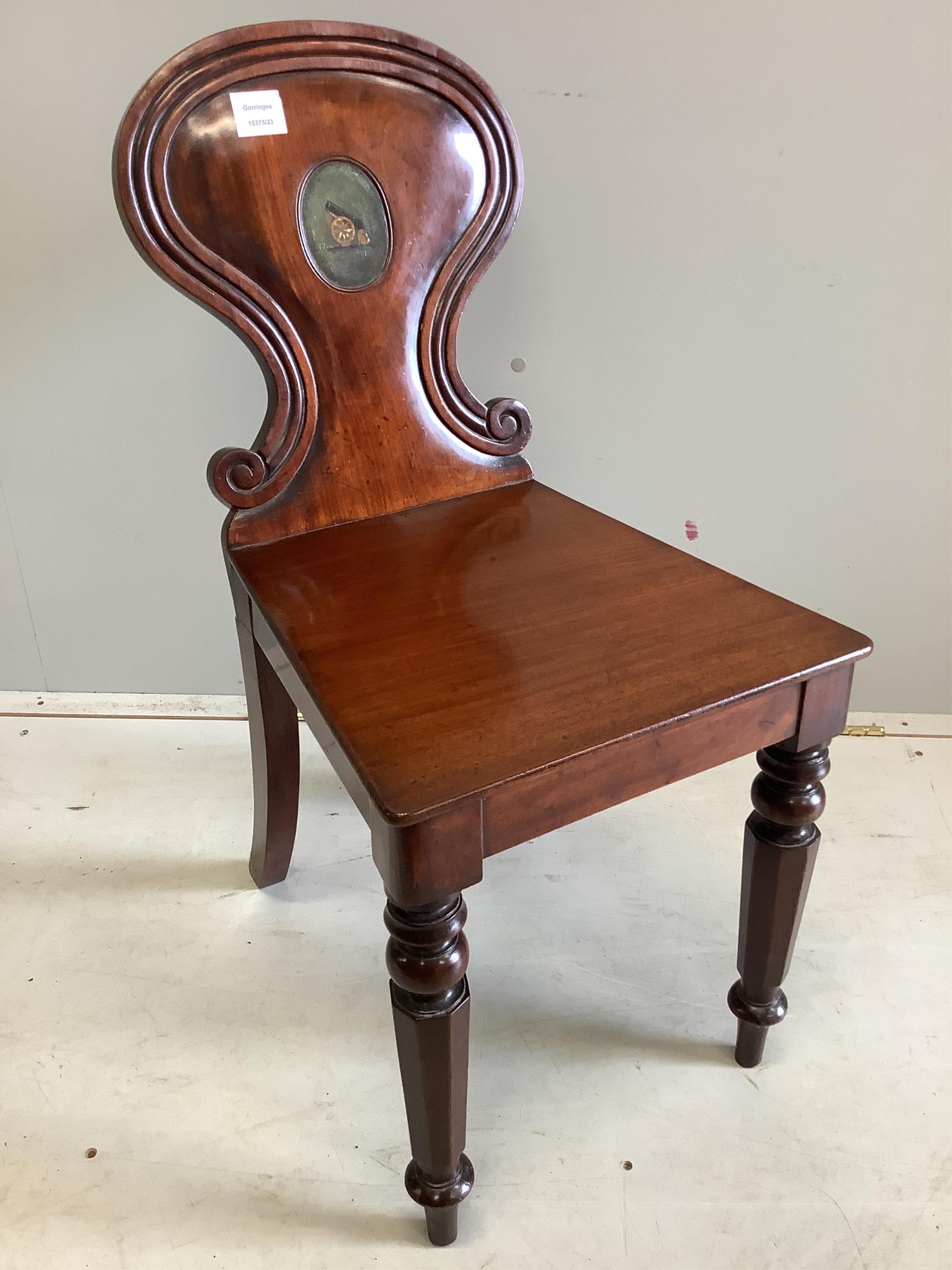 An early Victorian mahogany hall chair with painted armorial, width 38cm, depth 45cm, height 79cm. Condition - fair                                                                                                         