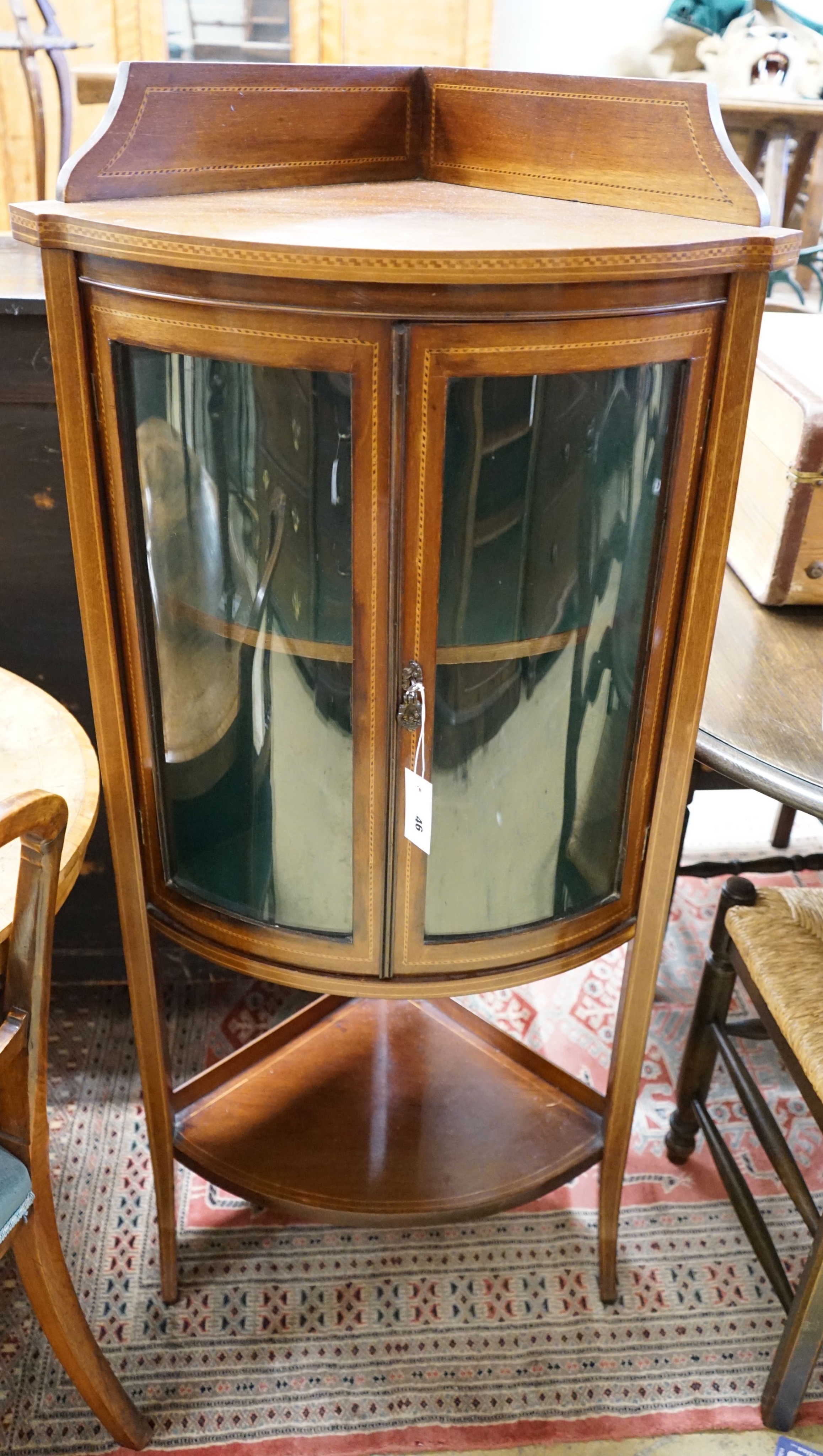An Edwardian inlaid mahogany bow fronted standing corner cupboard, width 60cm, depth 44cm, height 130cm                                                                                                                     