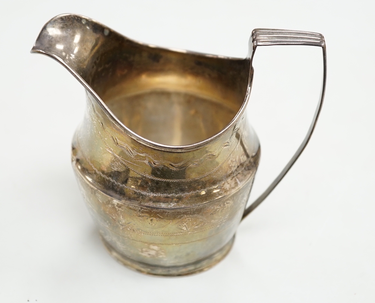 A George III engraved silver helmet shaped cream jug, London, 1801, 97mm, 3.3oz.                                                                                                                                            
