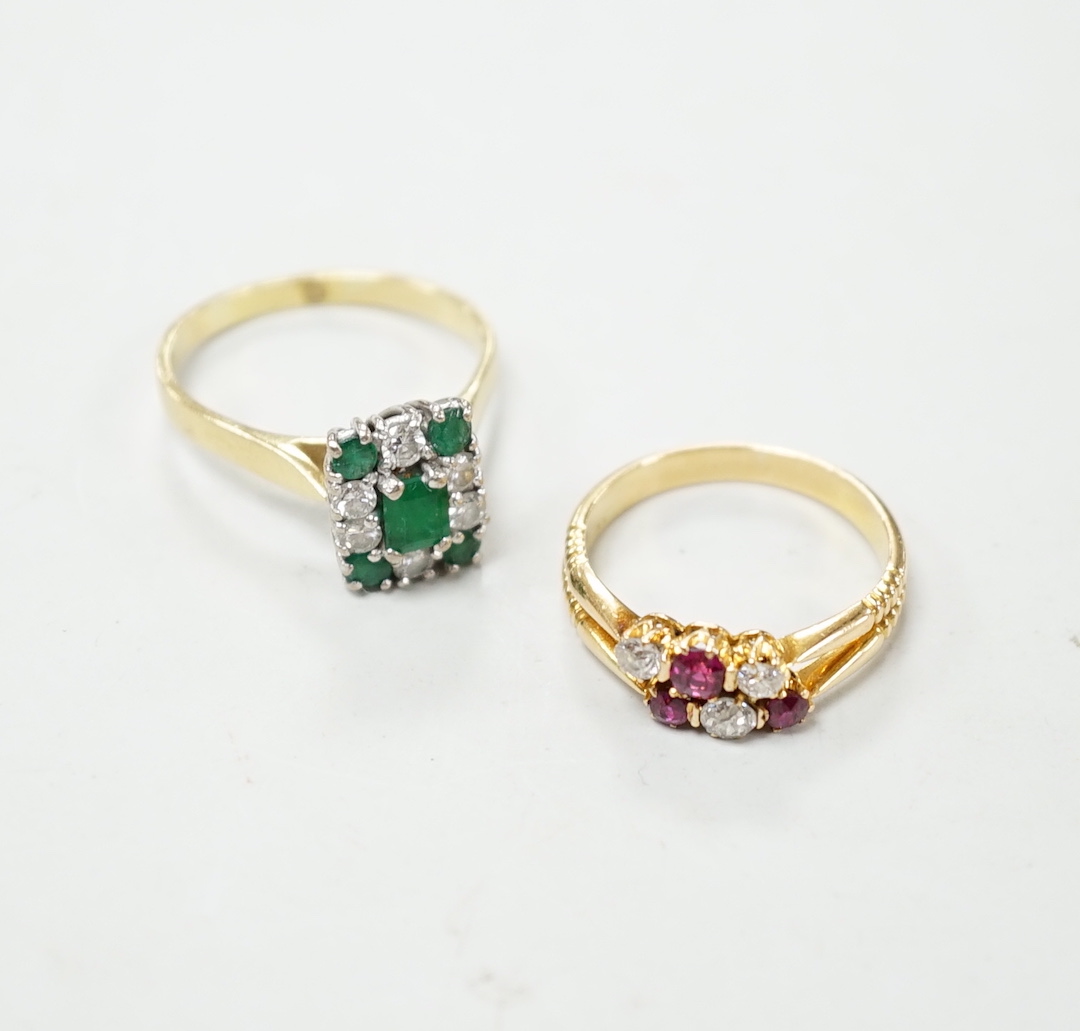 An 18ct, emerald and diamond set rectangular cluster ring, size R and an 18ct, ruby and diamond set cluster ring, size O, gross weight 8 rams.                                                                              