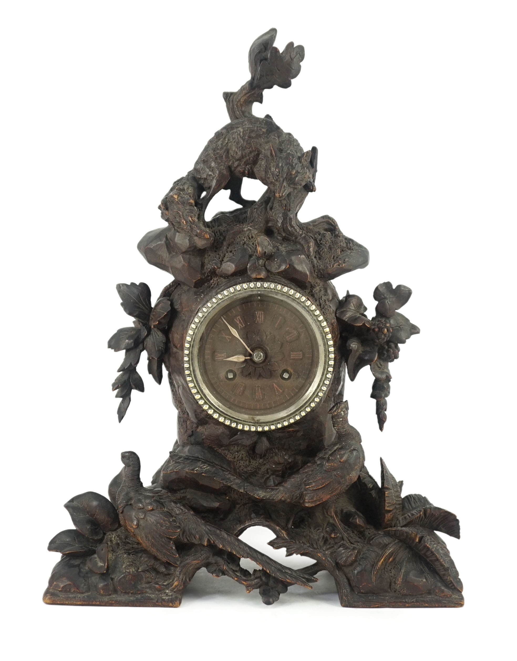 A 19th century Black Forest carved wood mantel timepiece, 30cm wide, 38cm high                                                                                                                                              