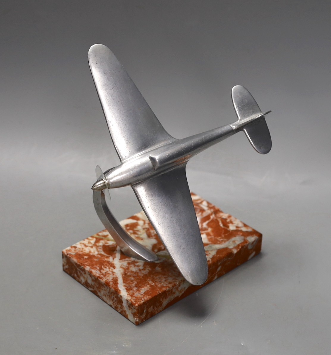 A mid 20th century aluminium model of a spitfire on ashtray marble base, spitfire 17cms wide                                                                                                                                