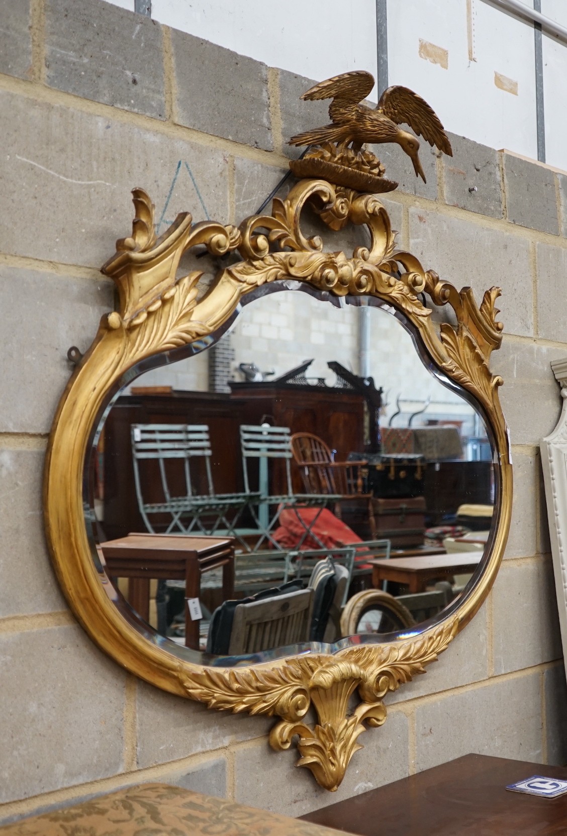A large carved late Victorian gilt framed wall mirror, width 112cm, height 115cm                                                                                                                                            