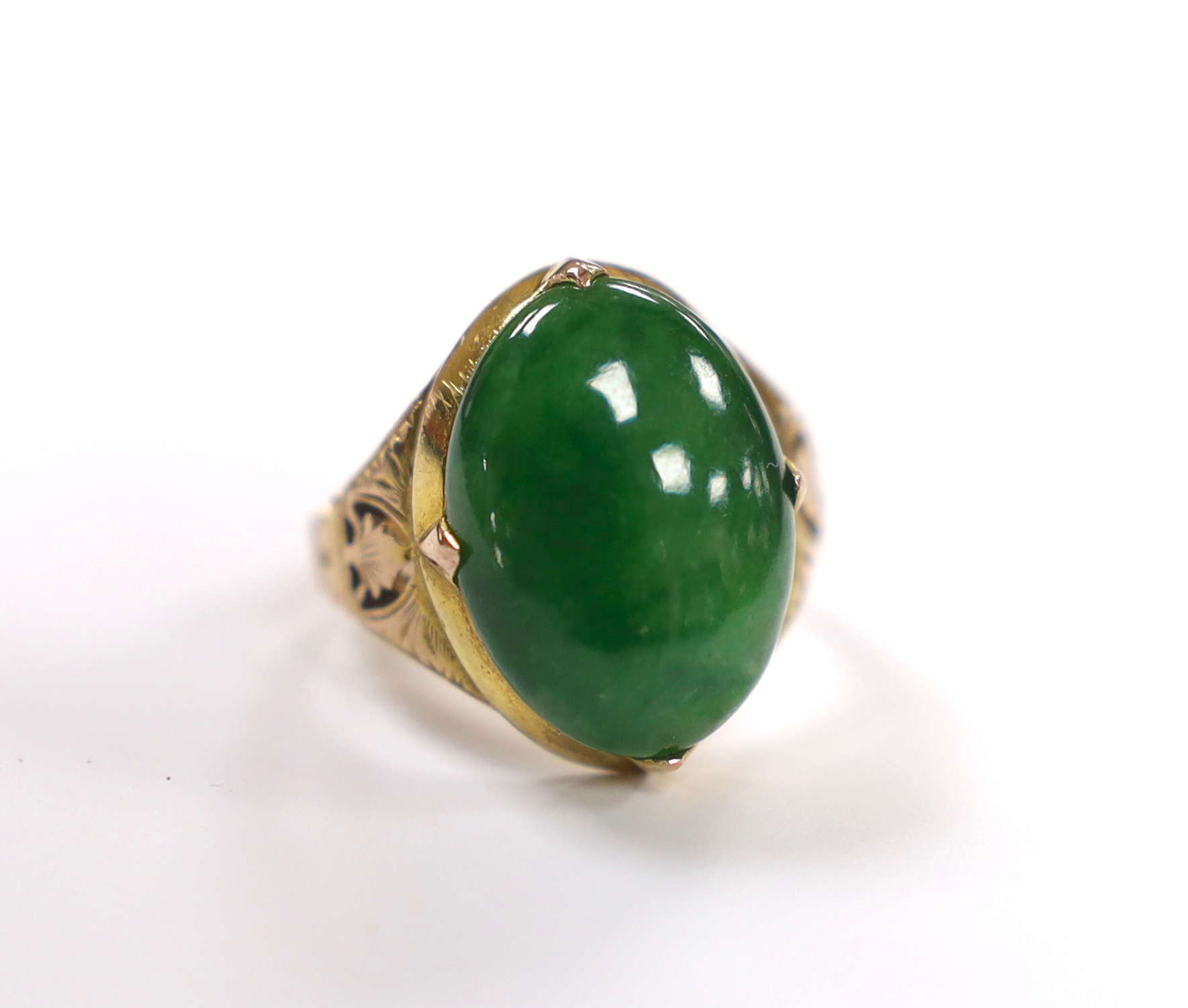 A Chinese 14k yellow metal and oval cabochon jade set ring, size I, gross weight 5.4 grams.                                                                                                                                 