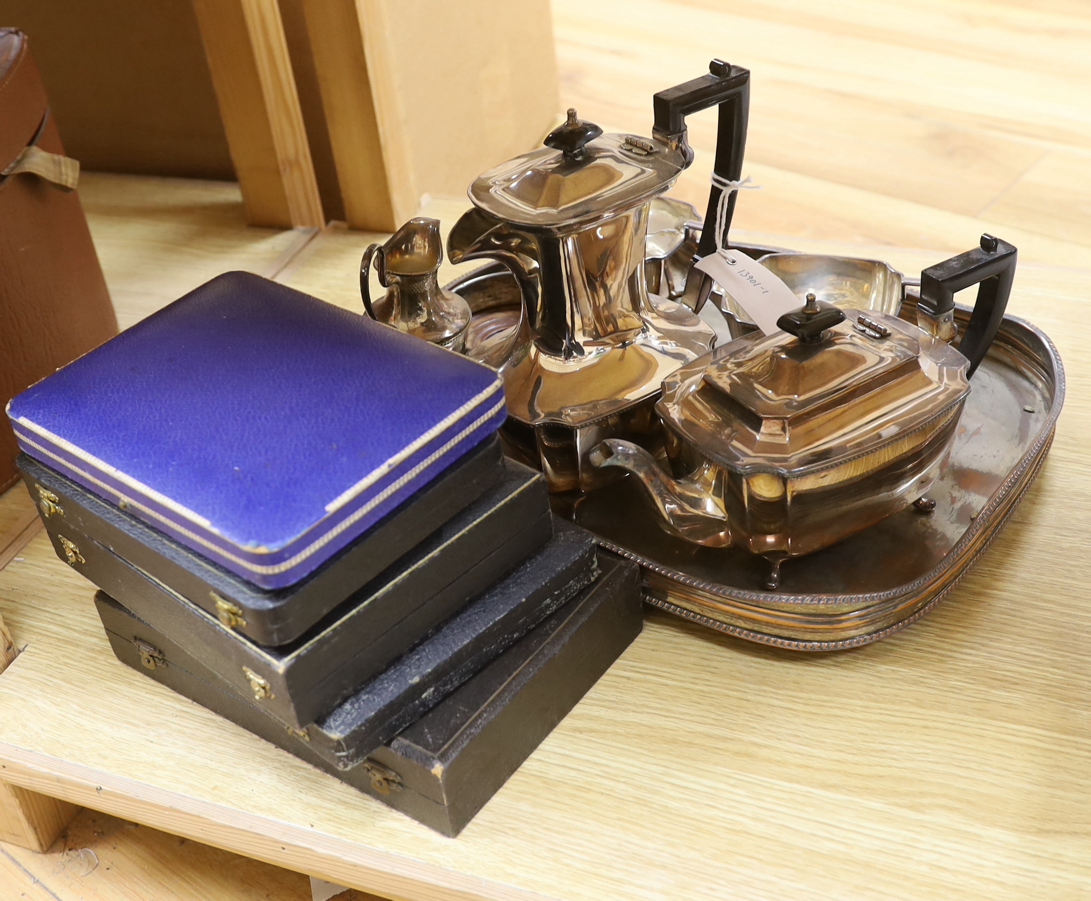 A four piece plated tea set, jug, coaster, tray and five boxed of cutlery                                                                                                                                                   