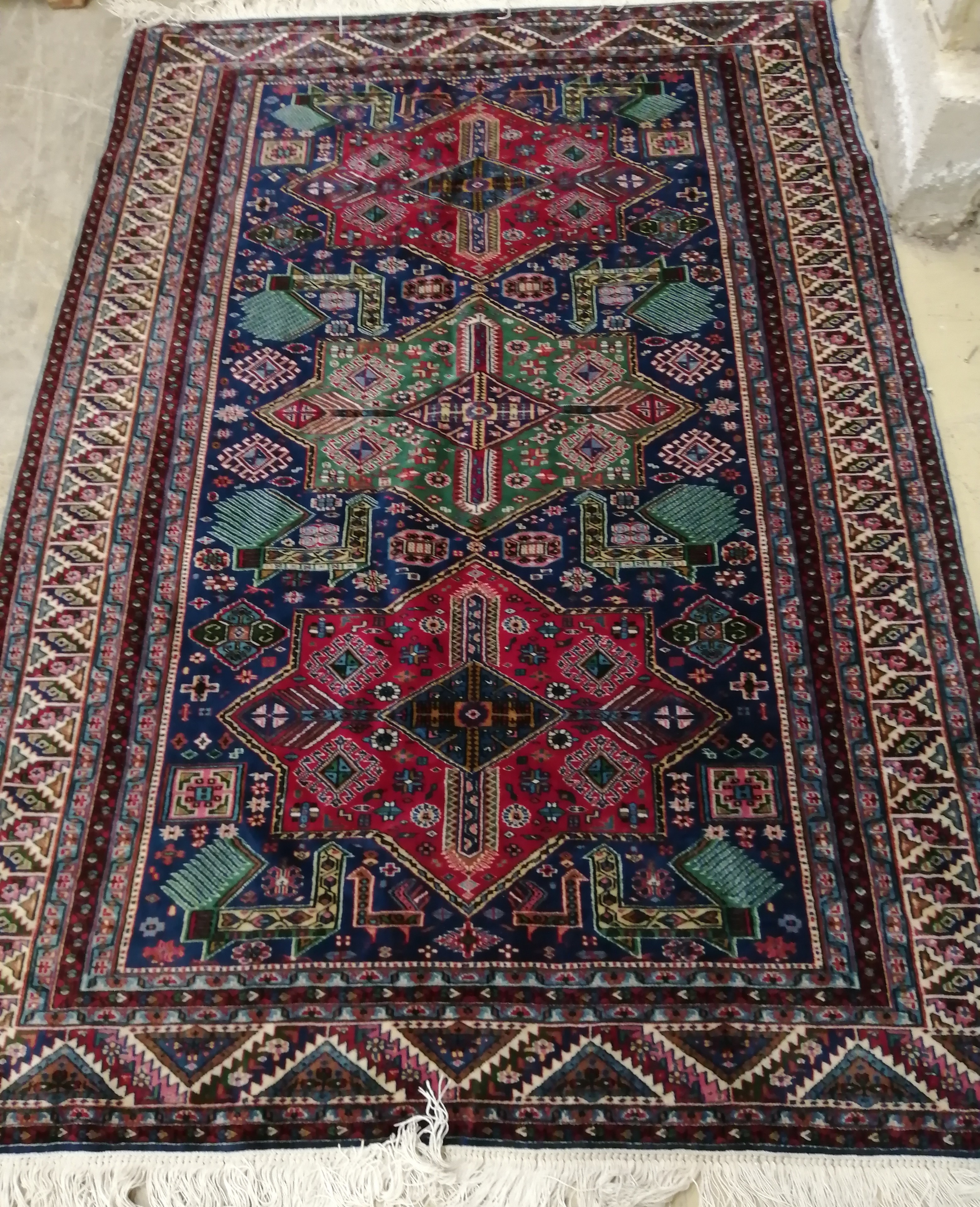 A Caucasian blue ground rug, 186 x 124cm                                                                                                                                                                                    