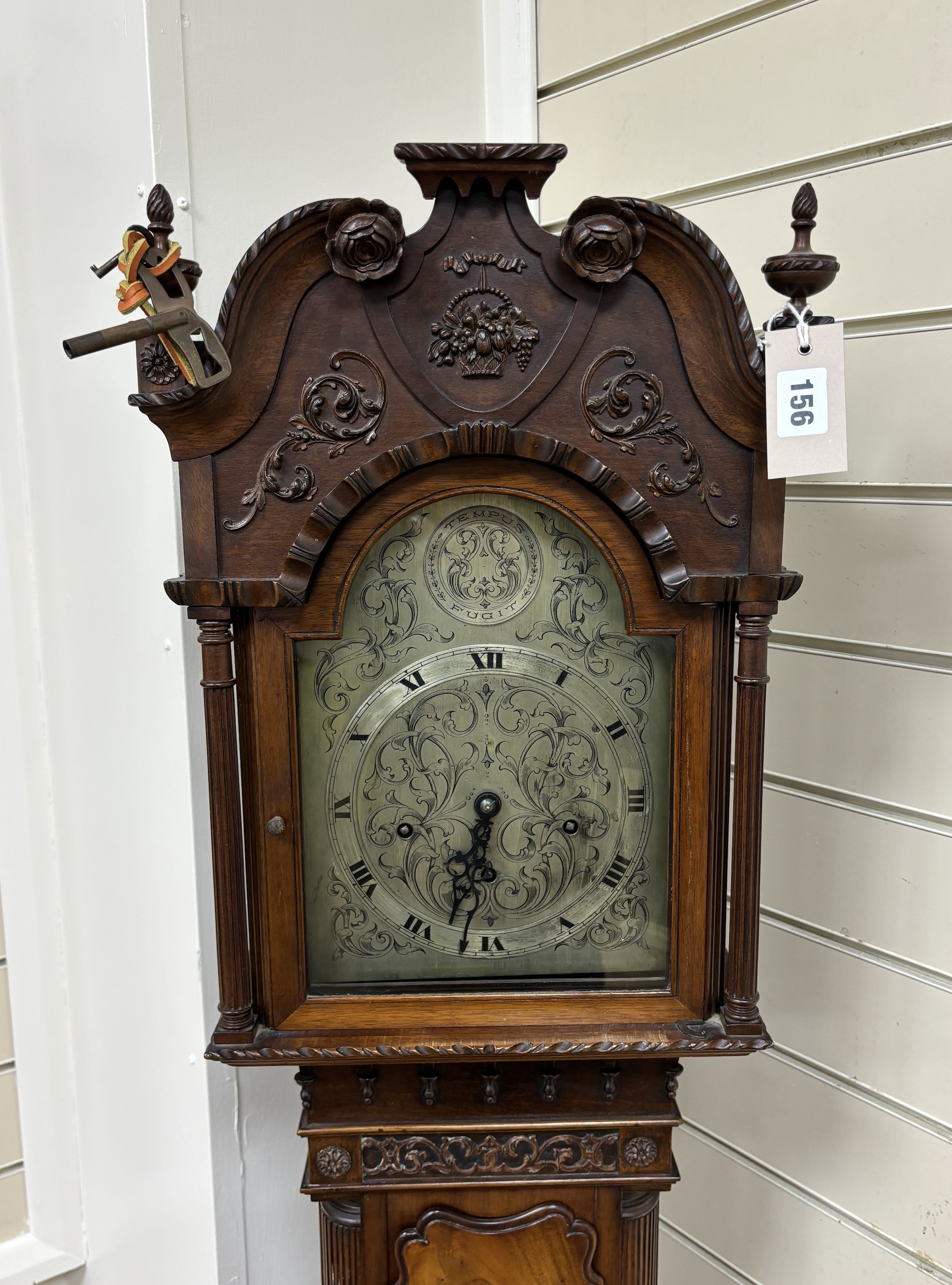 A 1920's George III style mahogany grandmother clock with arched silvered dial and three train movement, height 172cm.                                                                                                      