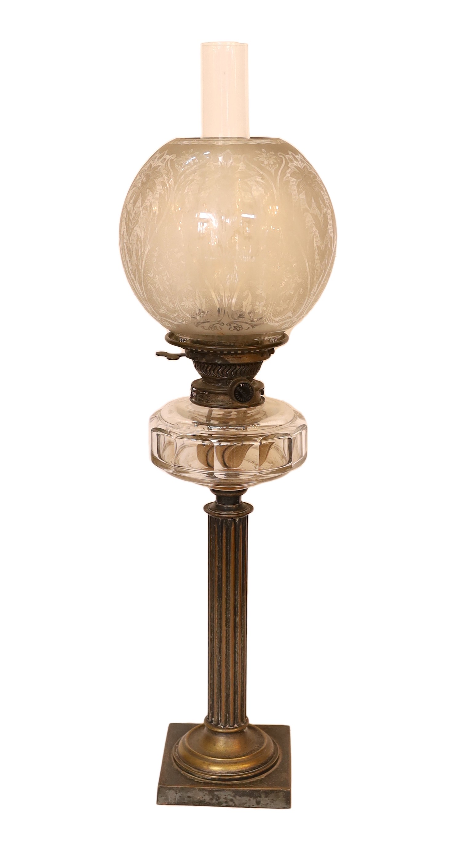An Edwardian brass column oil lamp with cut glass reservoir, ANCS mechanism and etched shade, height overall 70cm                                                                                                           
