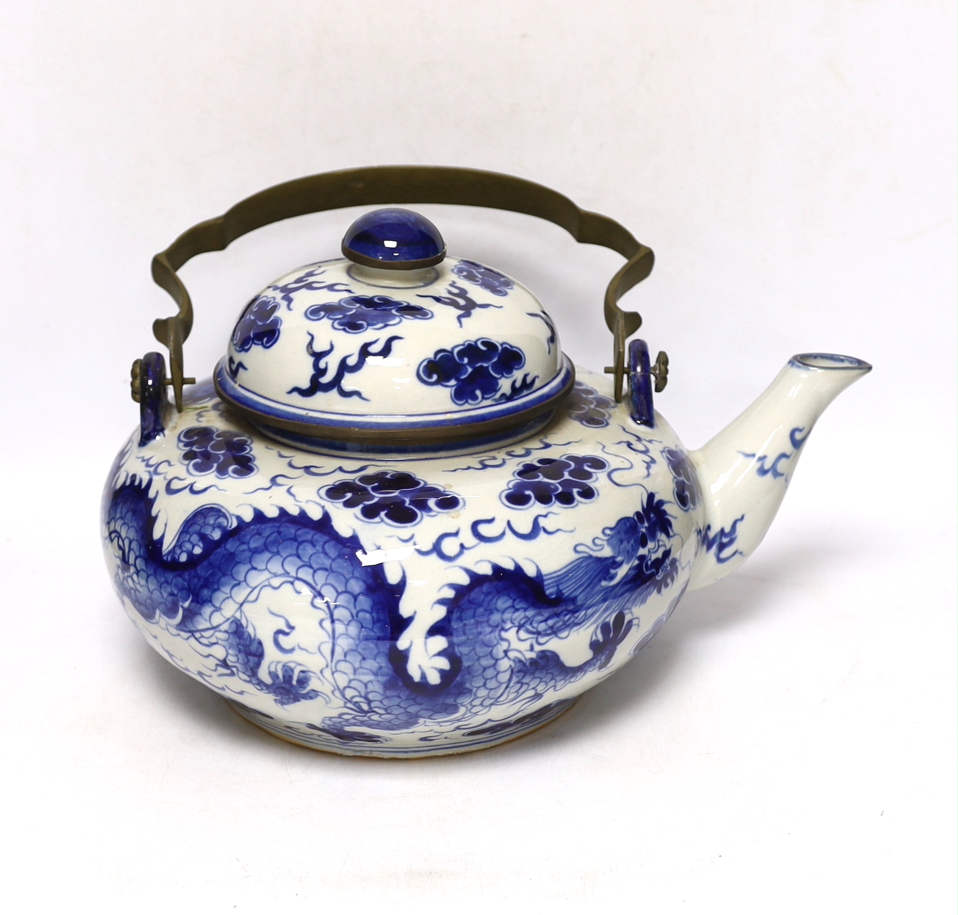 A large Chinese blue and white ‘dragon’ teapot, 38cm wide                                                                                                                                                                   