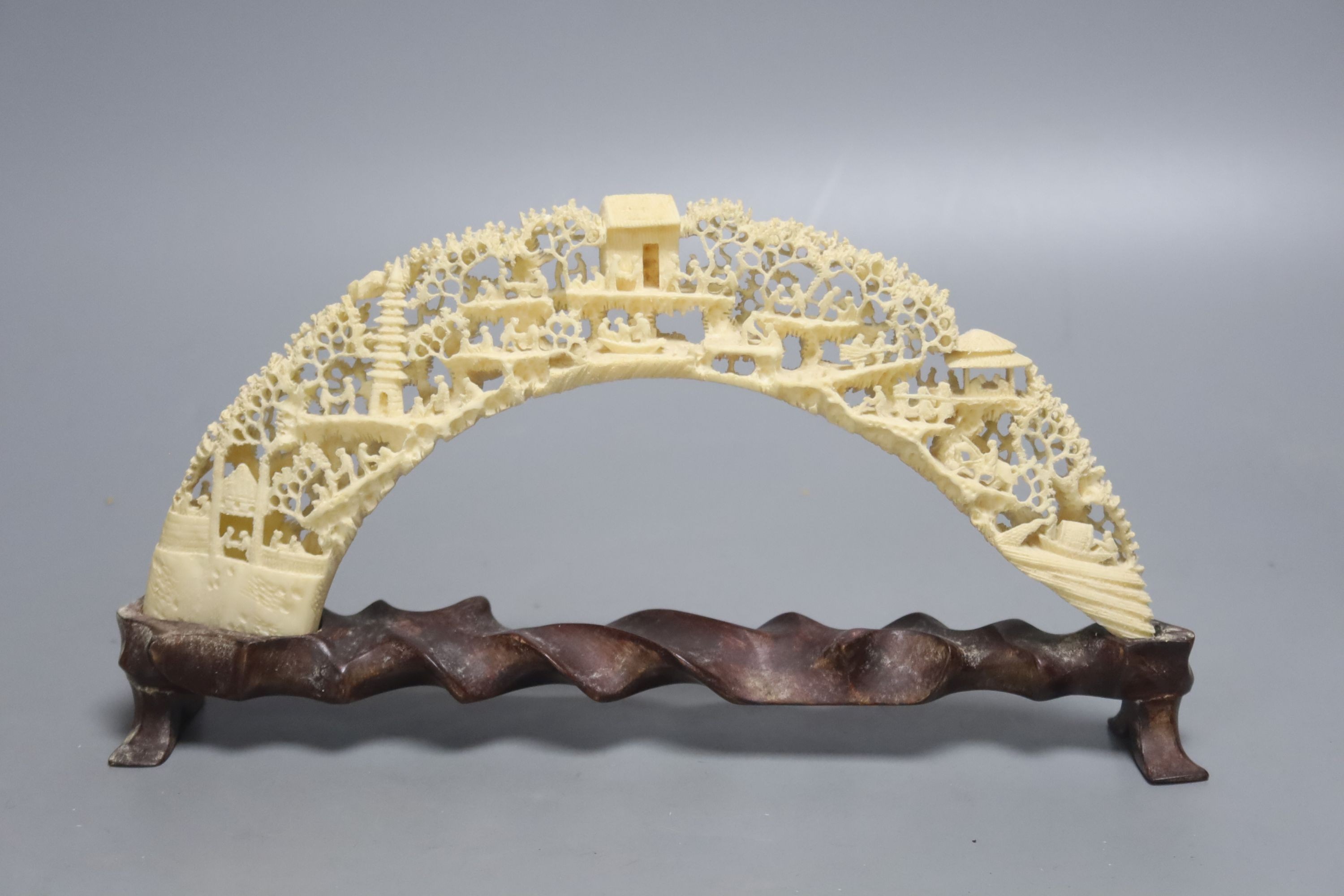 A 20th century Chinese carved and pierced boar’s tusk decorated with trees, 27cm wide                                                                                                                                       