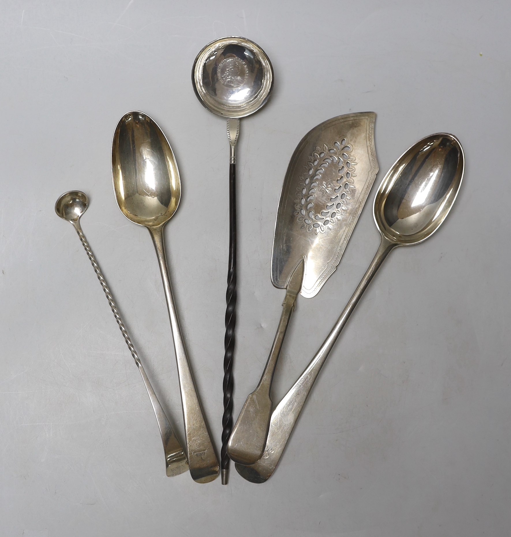 An 18th century silver Old English pattern basting spoon, marks pinched, a similar late Victorian basting spoon, London, 1893 and three other items including a George III silver fish slice, London, 1813.                 