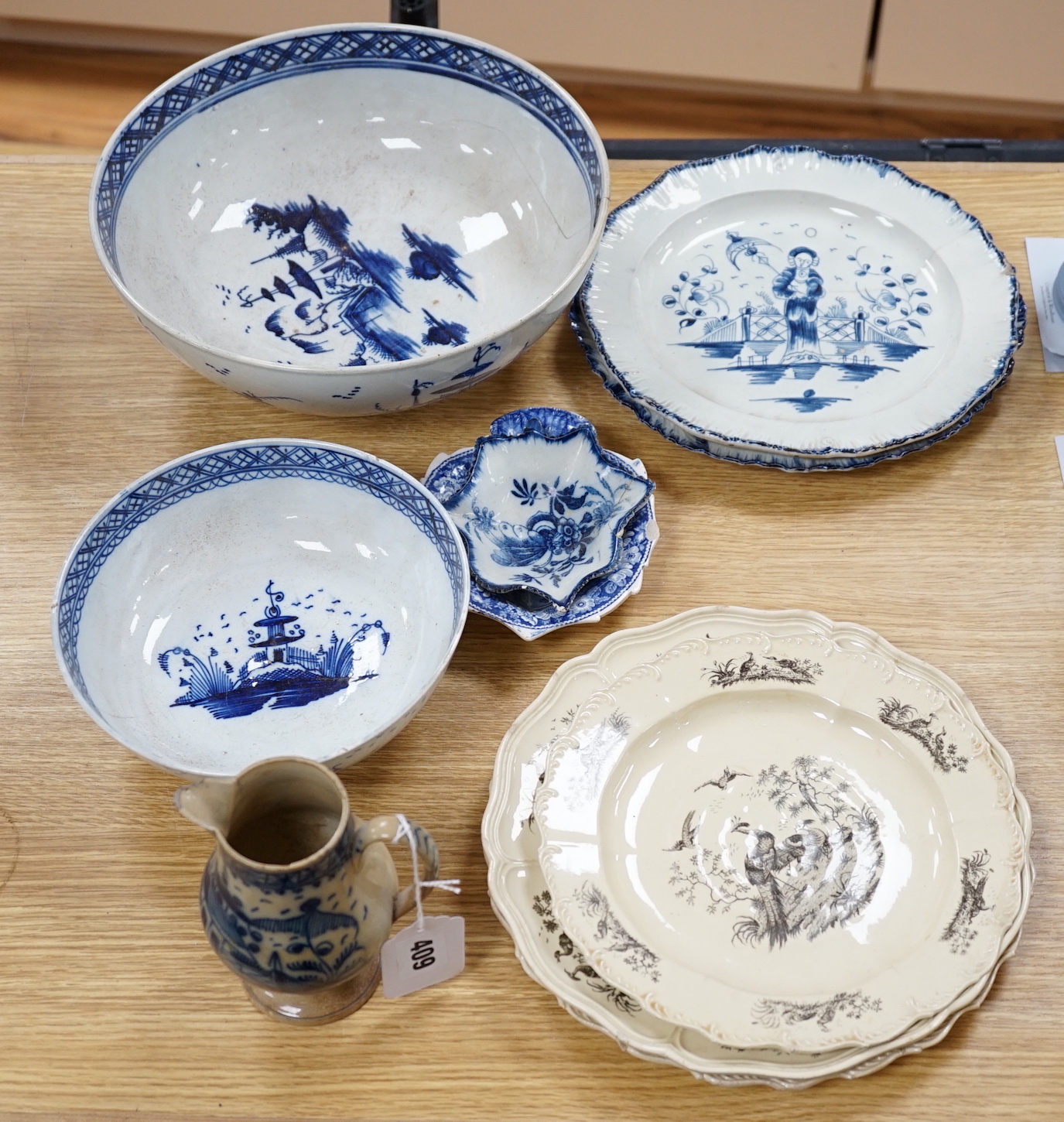 A collection of late 18th/early 19th century pearlware and creamware including three black transfer printed creamware plates, c.1780, blue and white bowls, plates, dishes and jug, the largest 27cm in diameter            