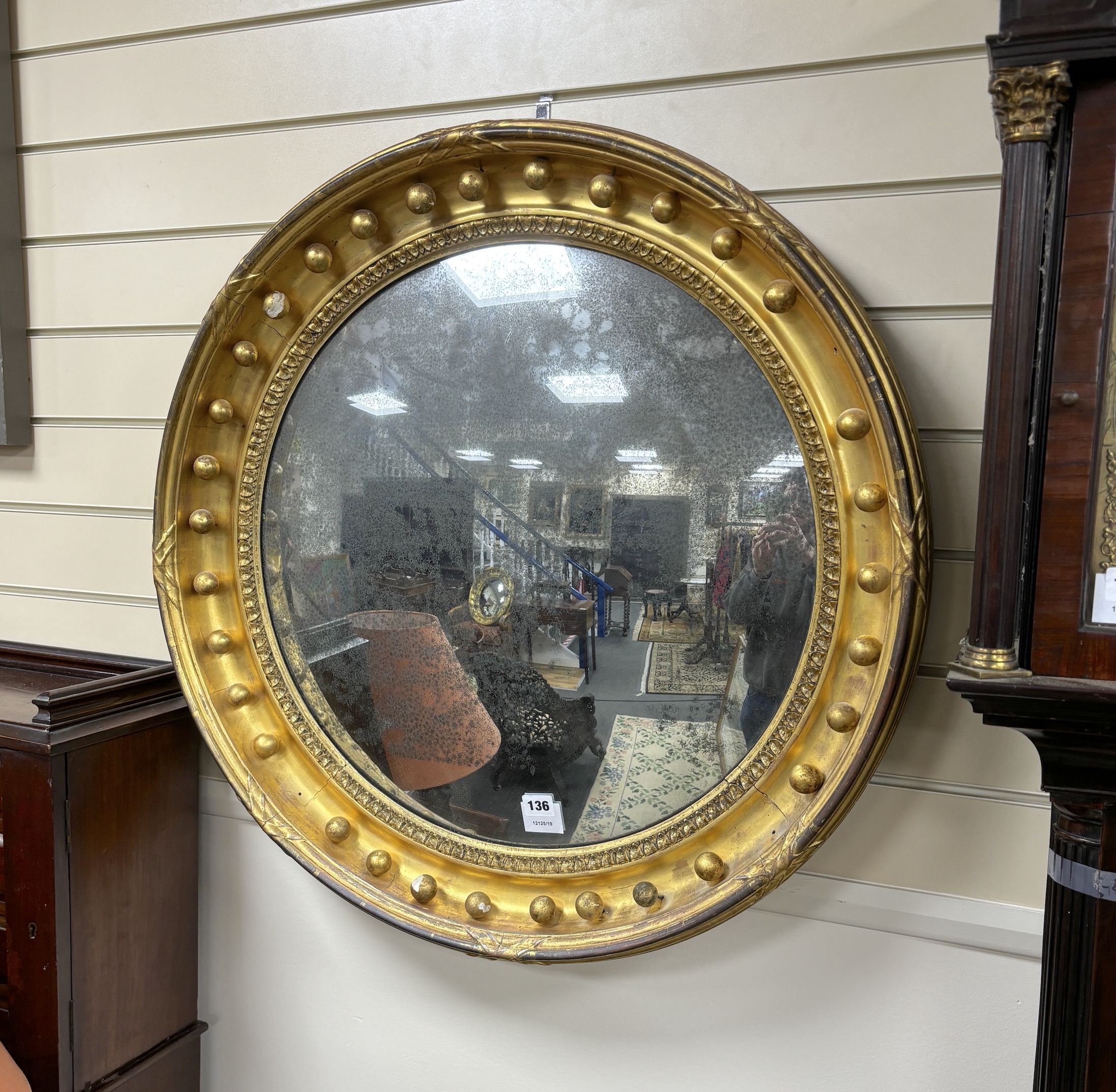 A large Regency giltwood and composition convex wall mirror, diameter 76cm                                                                                                                                                  