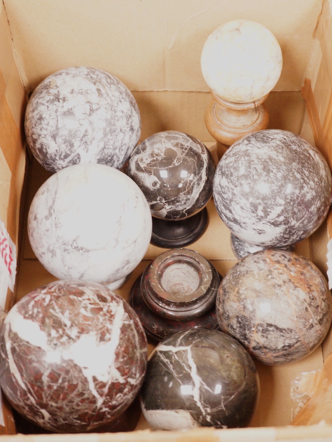 A quantity of carved marble balls on stands                                                                                                                                                                                 