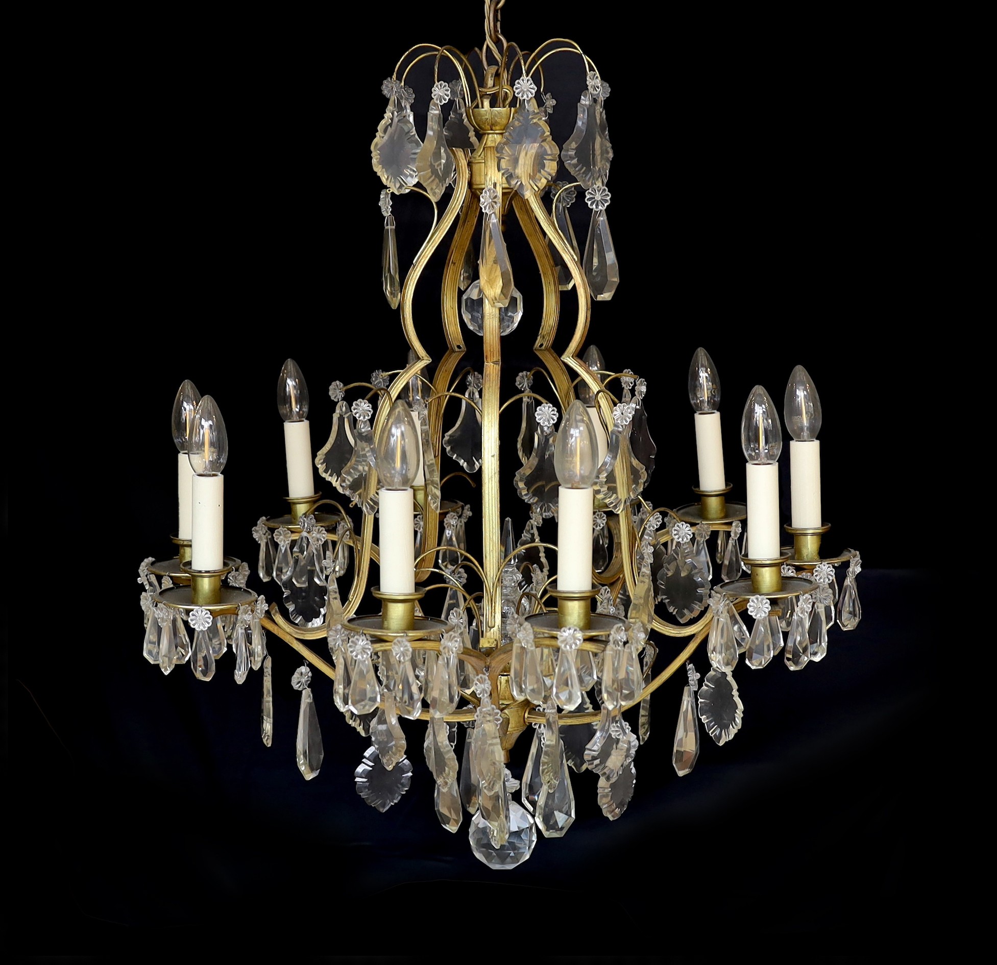 An early 20th century French silver and bronze and cut glass ten light chandelier hung with lozenge and tear shaped drops, drop 82cm. width 60cm                                                                            
