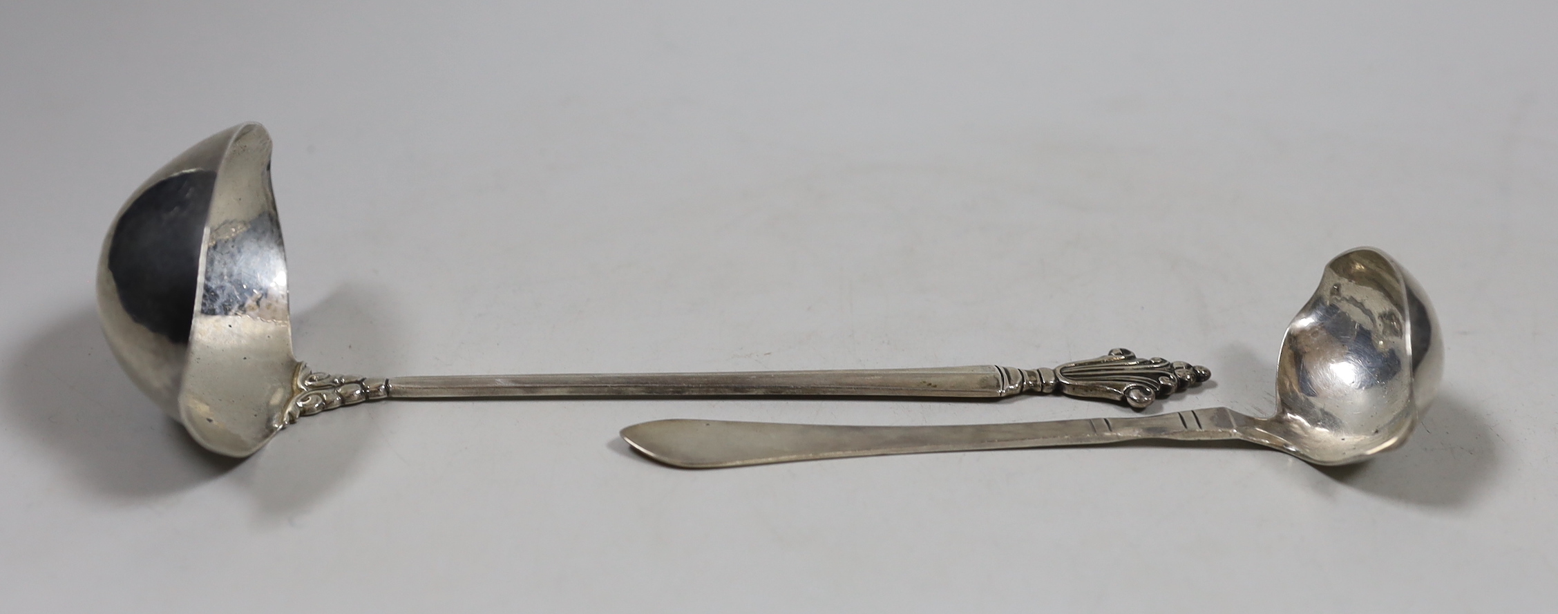 Two Georg Jenson sterling silver ladles, import marks for London, 1926, largest 19cm.                                                                                                                                       