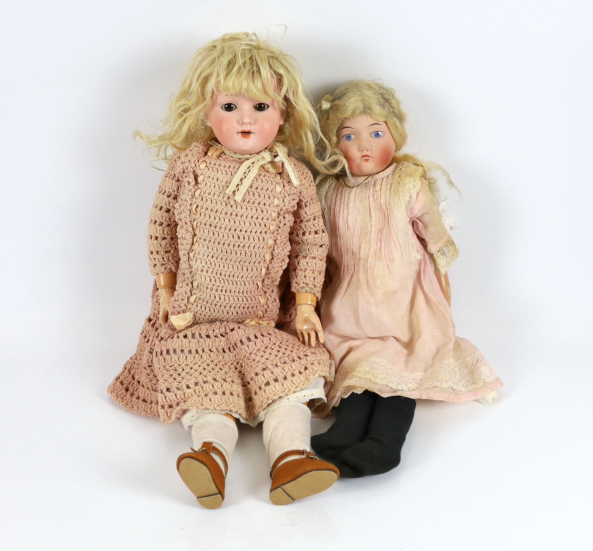 An AM 390 on jointed body with original dress and wig, 50cm, together with an English doll soft body, 45cm                                                                                                                  