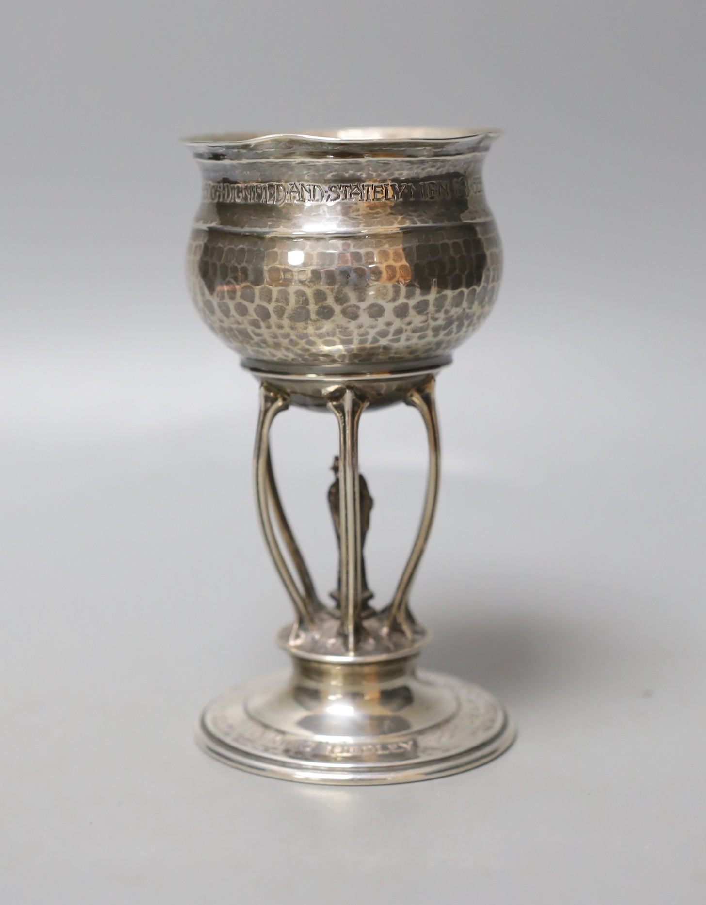A George V Arts & Crafts planished silver presentation ecclesiastical goblet by Ramsden & Carr, with engraved inscription, London, 1911, 13.5cm, 152 grams.                                                                 