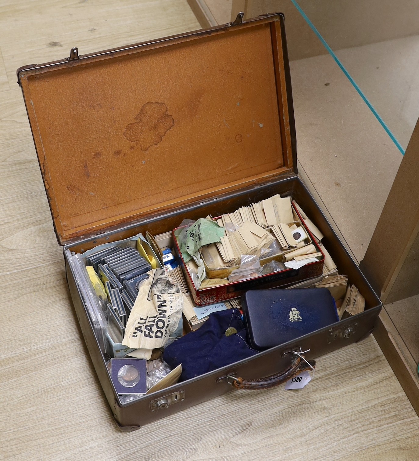 A collection of UK and Commonwealth coins and tokens 18th–20th century, the majority George VI onwards including commemorative crowns a 1974 coinage of Barbados set, a Victoria half Farthing etc . In a suitcase          