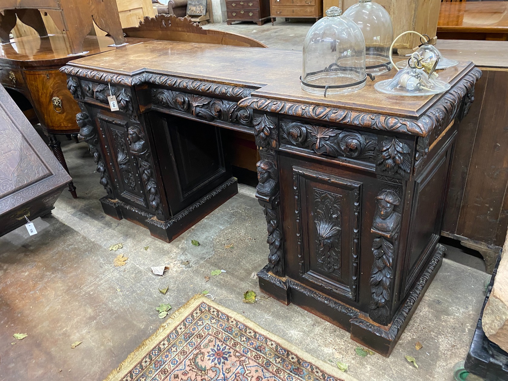 A 19th century Flemish carved oak inverse breakfront pedestal sideboard, length 183cm, depth 60cm, height 92cm, together with a Victorian mahogany mirrored sideboard back                                                  
