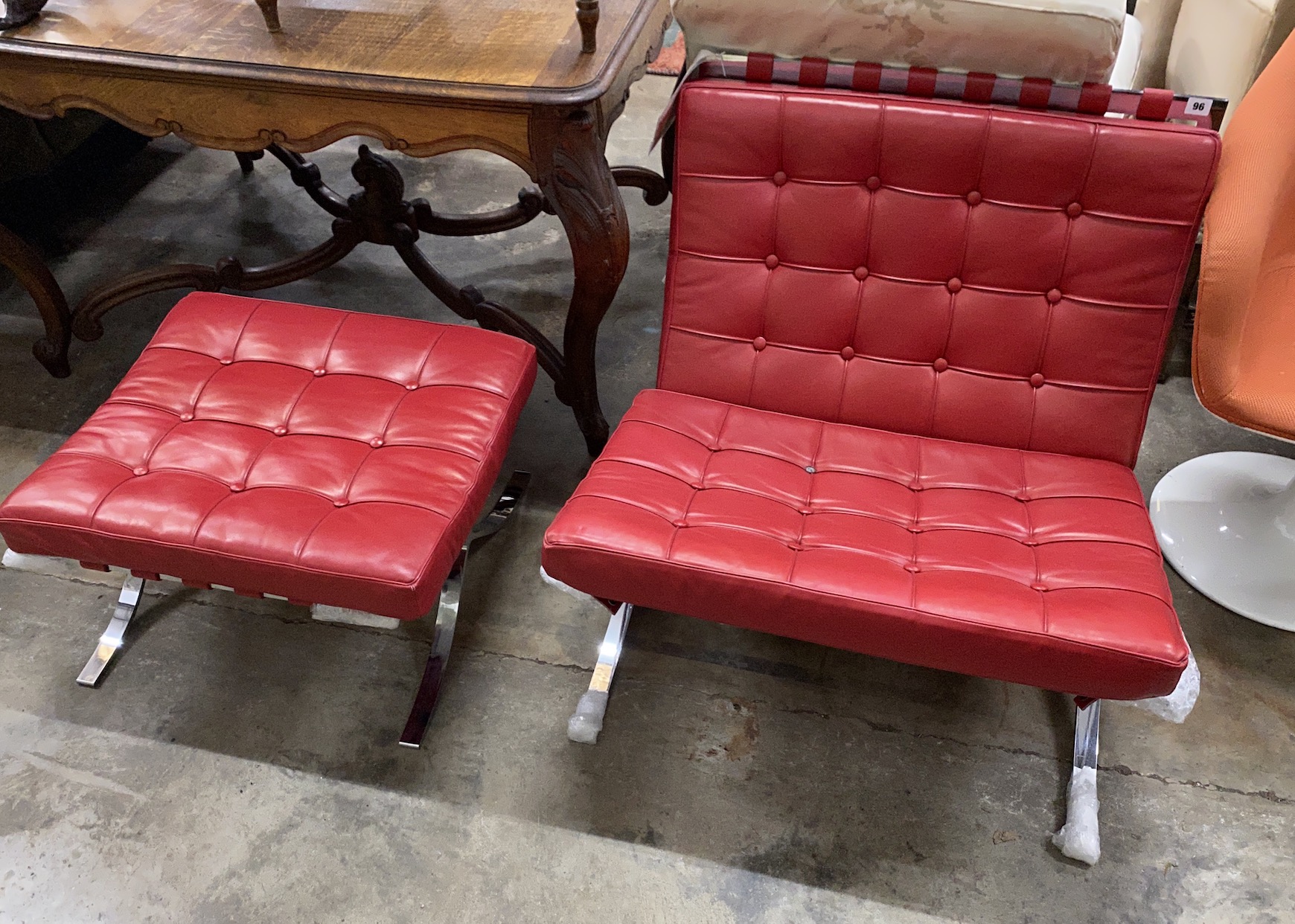 A Knoll Studio Barcelona style red leather and chrome chair, width 75cm, depth 75cm, height 74cm and footstool                                                                                                              