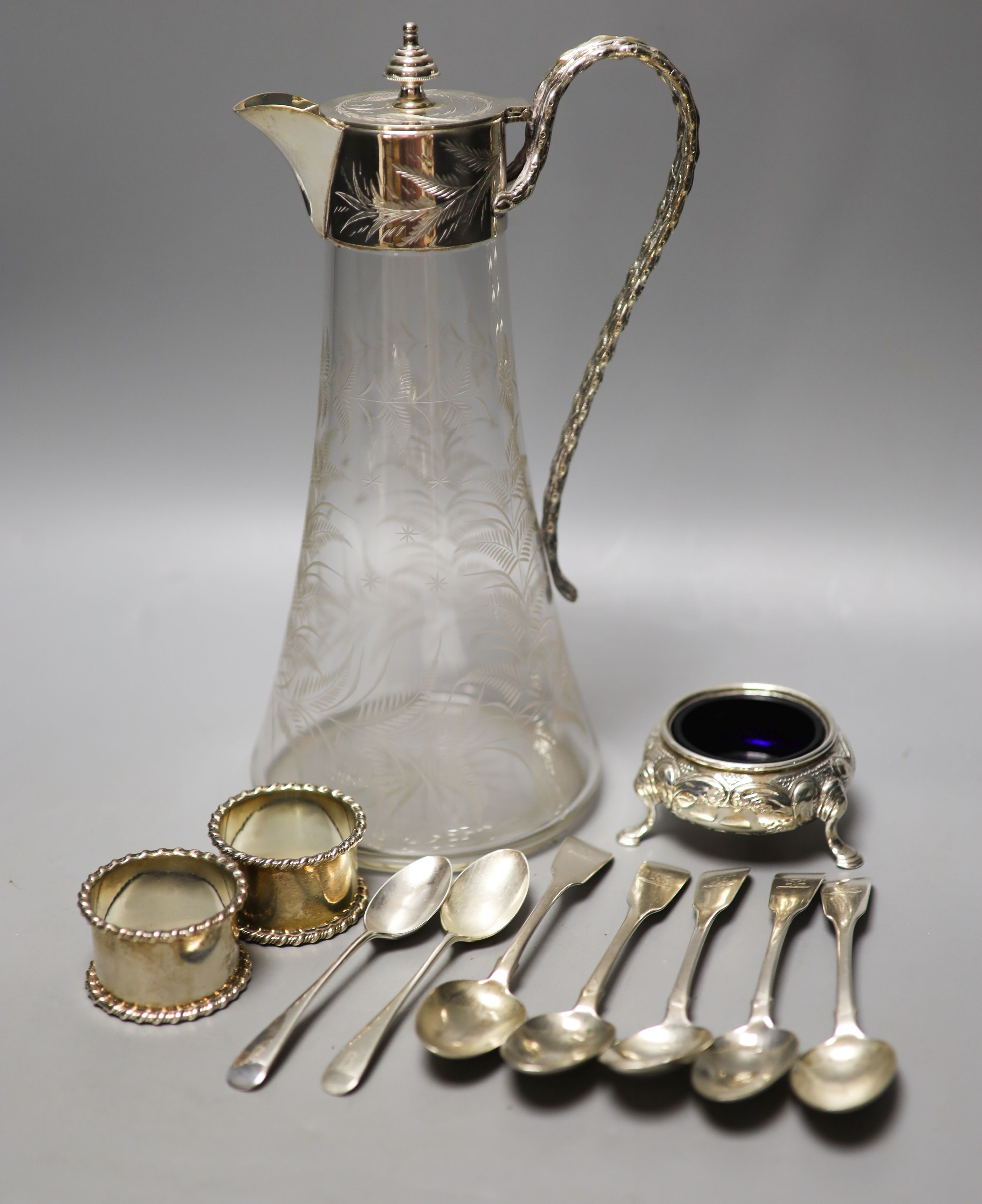 Five 19th century Irish silver fiddle pattern teaspoons, by Isaacs, two similar Scottish teaspoons, a pair if silver napkin rings, a Victorian silver bun salt and a silver plate mounted glass claret jug.                 