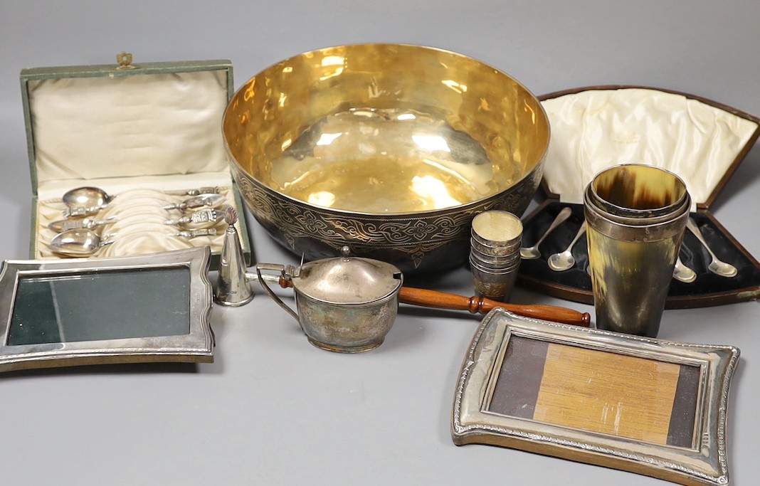 Assorted silver and other items including two silver mounted photograph frames, a Georgian silver mustard by John Eames, a graduated suite of three Victorian silver mounted horn beakers, a silver candle extinguisher, a c