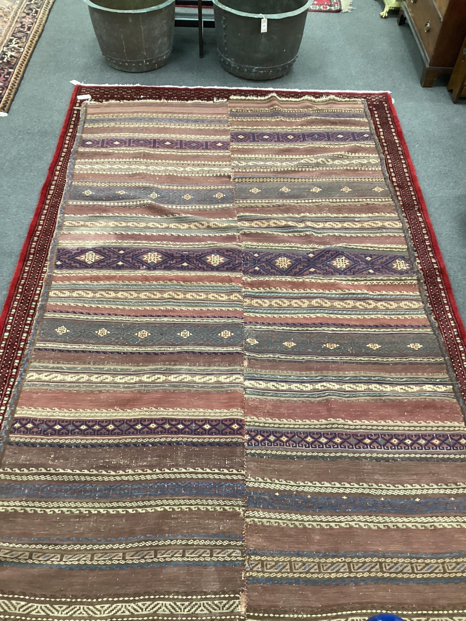 An antique polychrome flatweave carpet (cut centrally and re-stitched), 284 x 163cm                                                                                                                                         