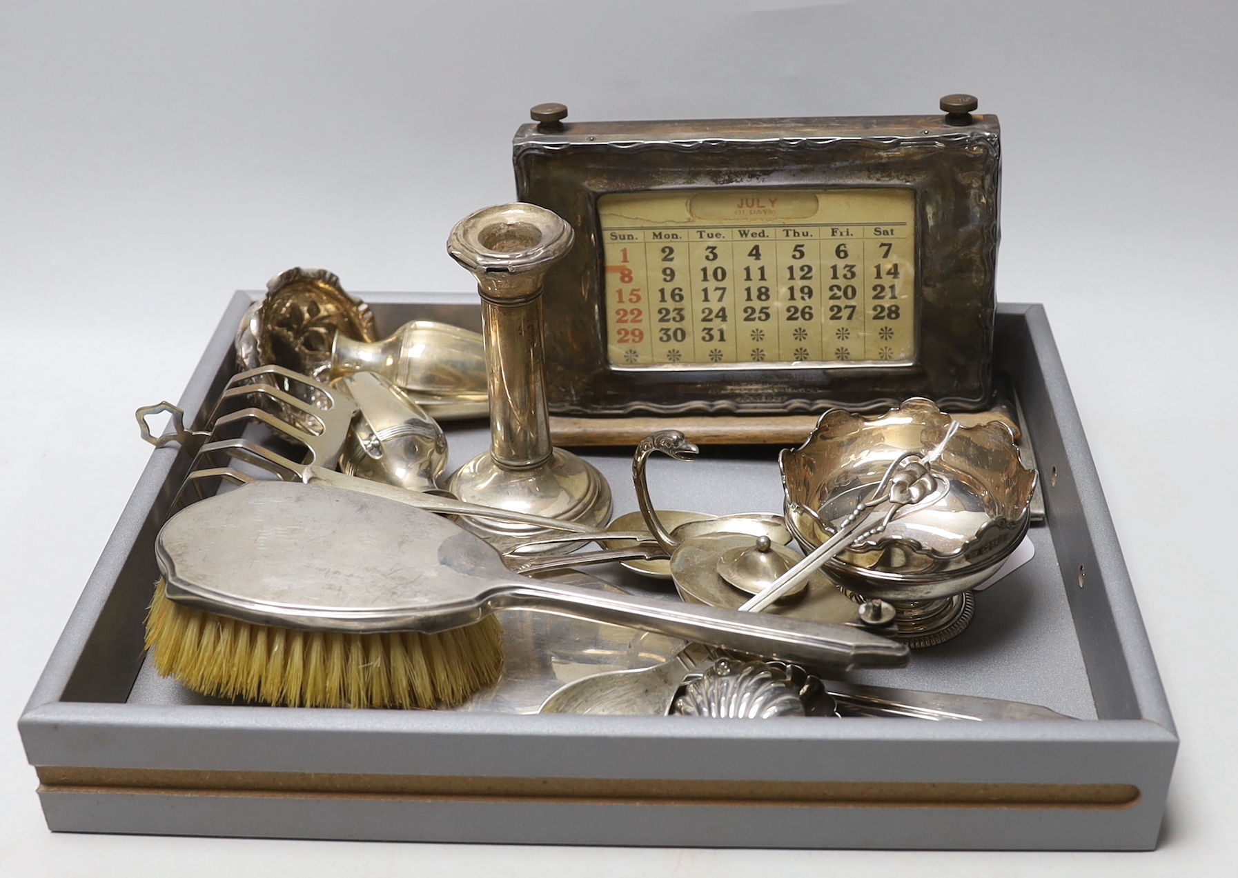 A group of small silverwares including toast rack, cigarette case, miniature Monteith style bowl, pair of shell salts, pair of small vases, desk calendar etc.                                                              