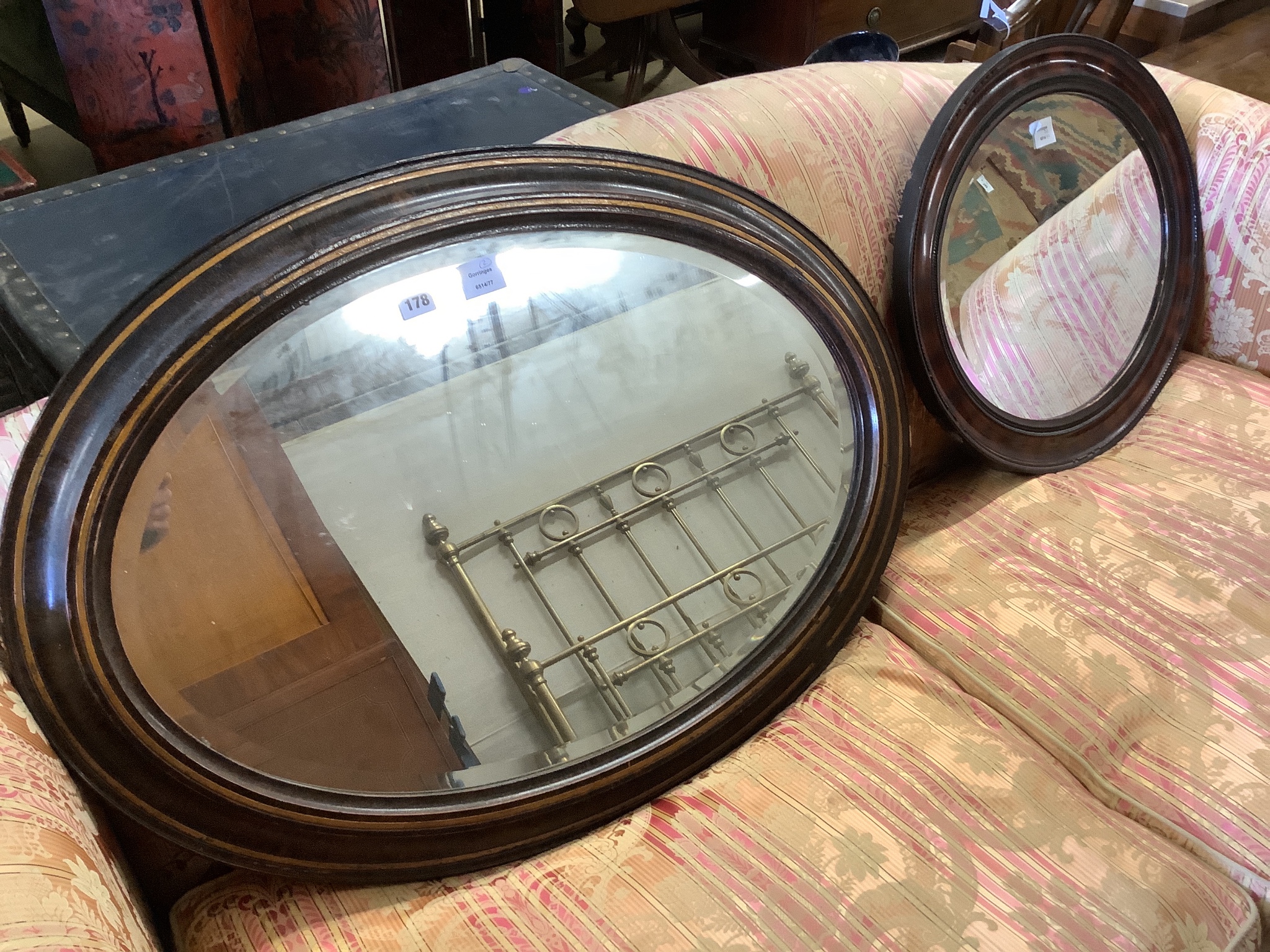 An Edwardian oval simulated tortoiseshell mirror and one other mirror, larger width 90cm, height 65cm                                                                                                                       