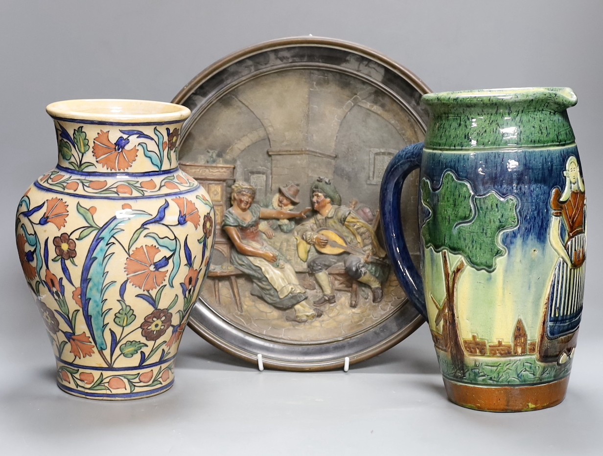 A Dutch jug, a polychrome vase and a Maresch Musterschutz moulded wall plaque, 33 cm diameter                                                                                                                               