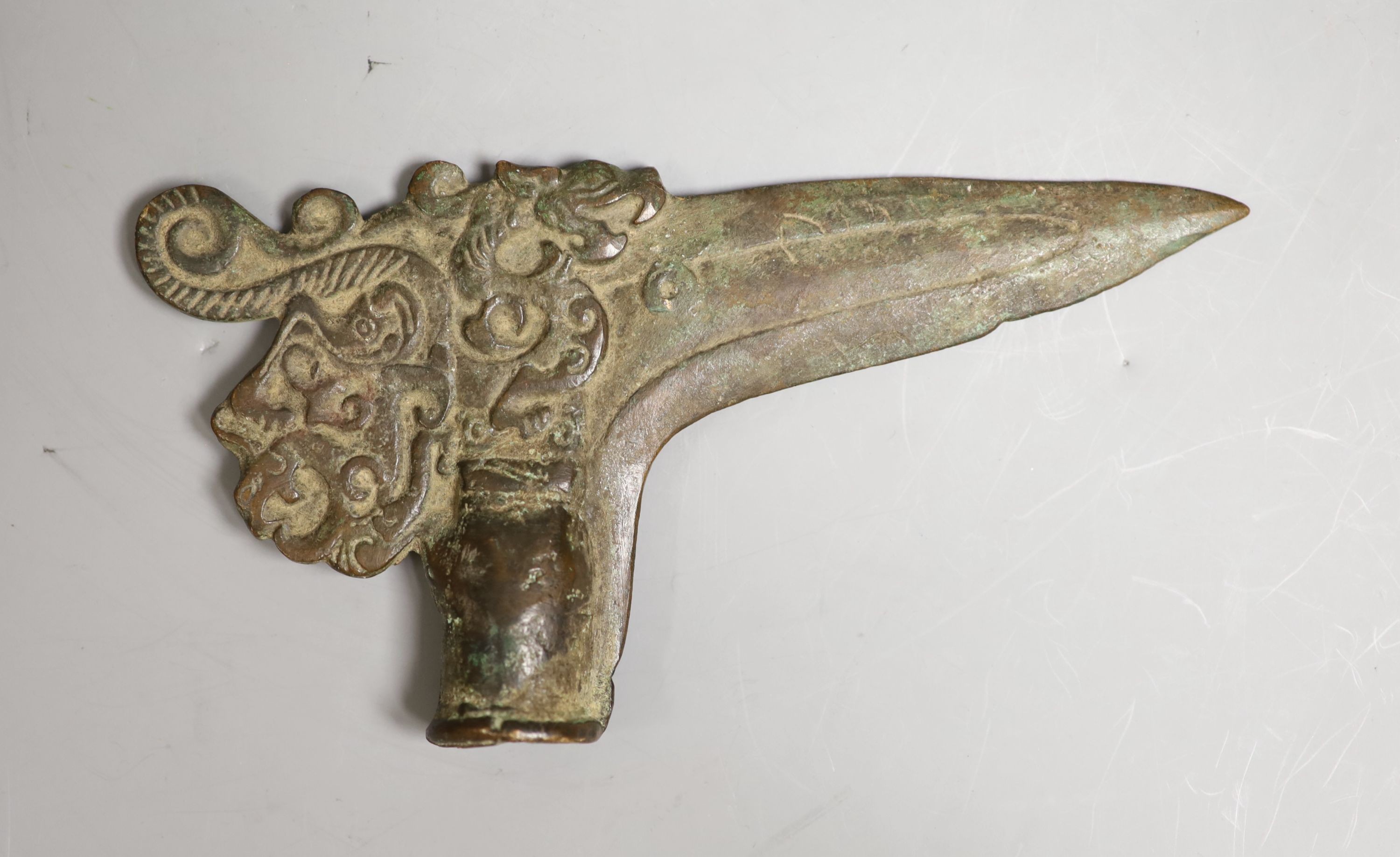 A Chinese bronze axe head, 17cm wide                                                                                                                                                                                        