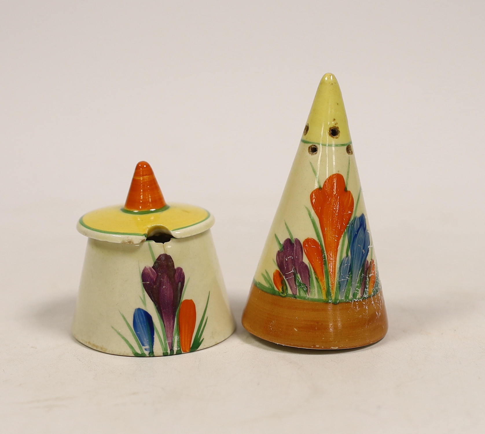 A Clarice Cliff crocus pattern mustard pot and pepper pot, largest 8cm high                                                                                                                                                 