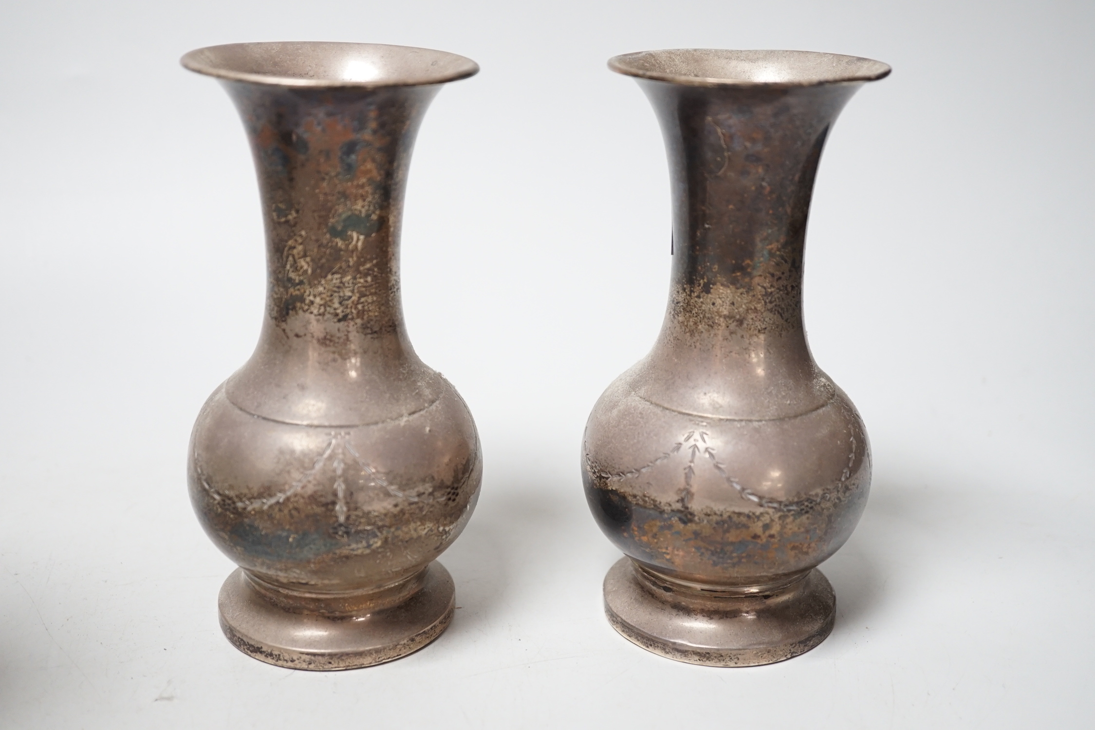 A pair of George V silver mounted spill vases, Birmingham, 1934, 14.2cm, weighted.                                                                                                                                          
