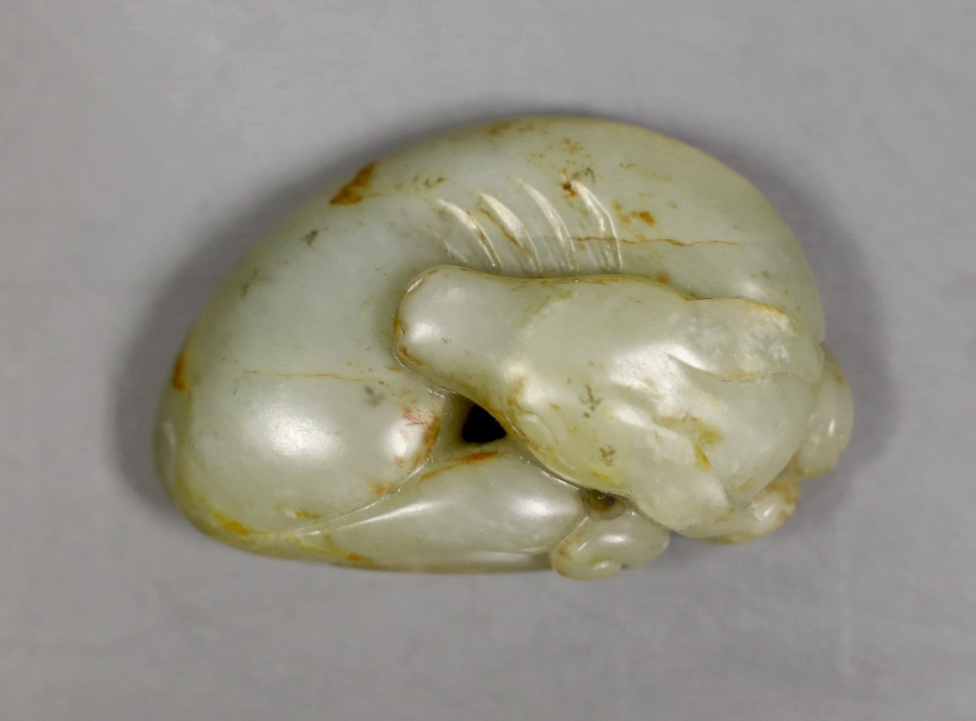 A Chinese jade carving of a sleeping dog, 6cm wide                                                                                                                                                                          