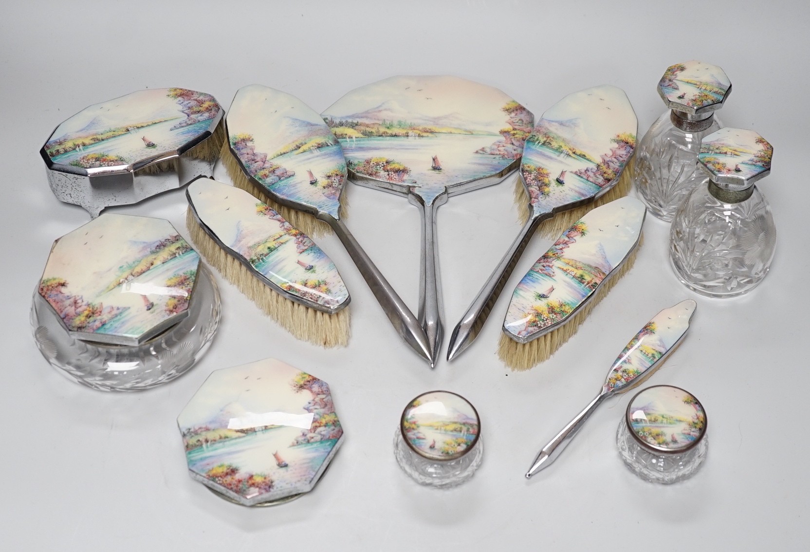 A twelve piece chrome plated and enamel dressing table set                                                                                                                                                                  