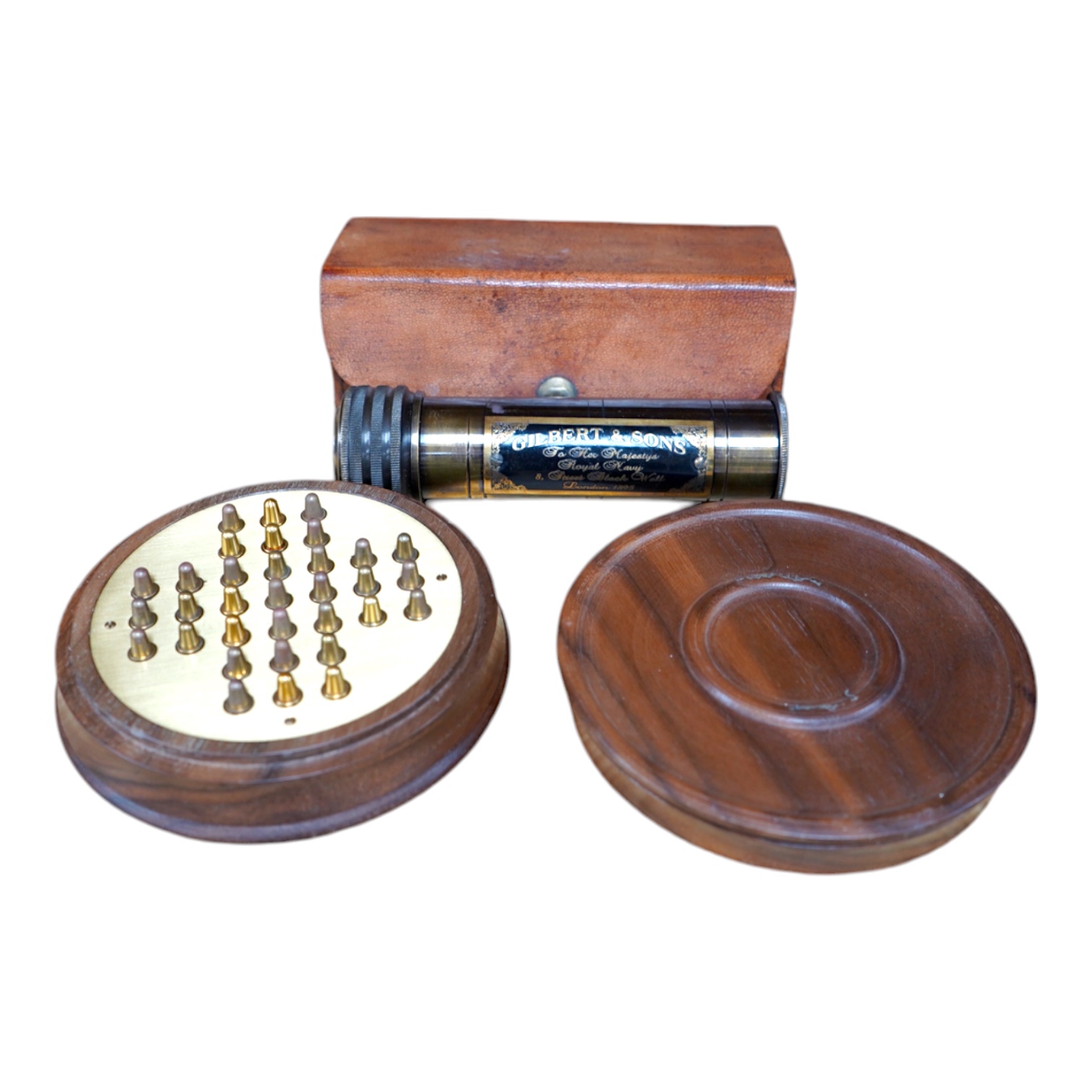 A reproduction 19th century style brass kaleidoscope with panel reading; ‘Gilbert & Sons To Her Majesty’s Royal Navy, 8 Street Black Wall, London 1895’, 13.5cm long, in a leather case, together with a wood cased brass so