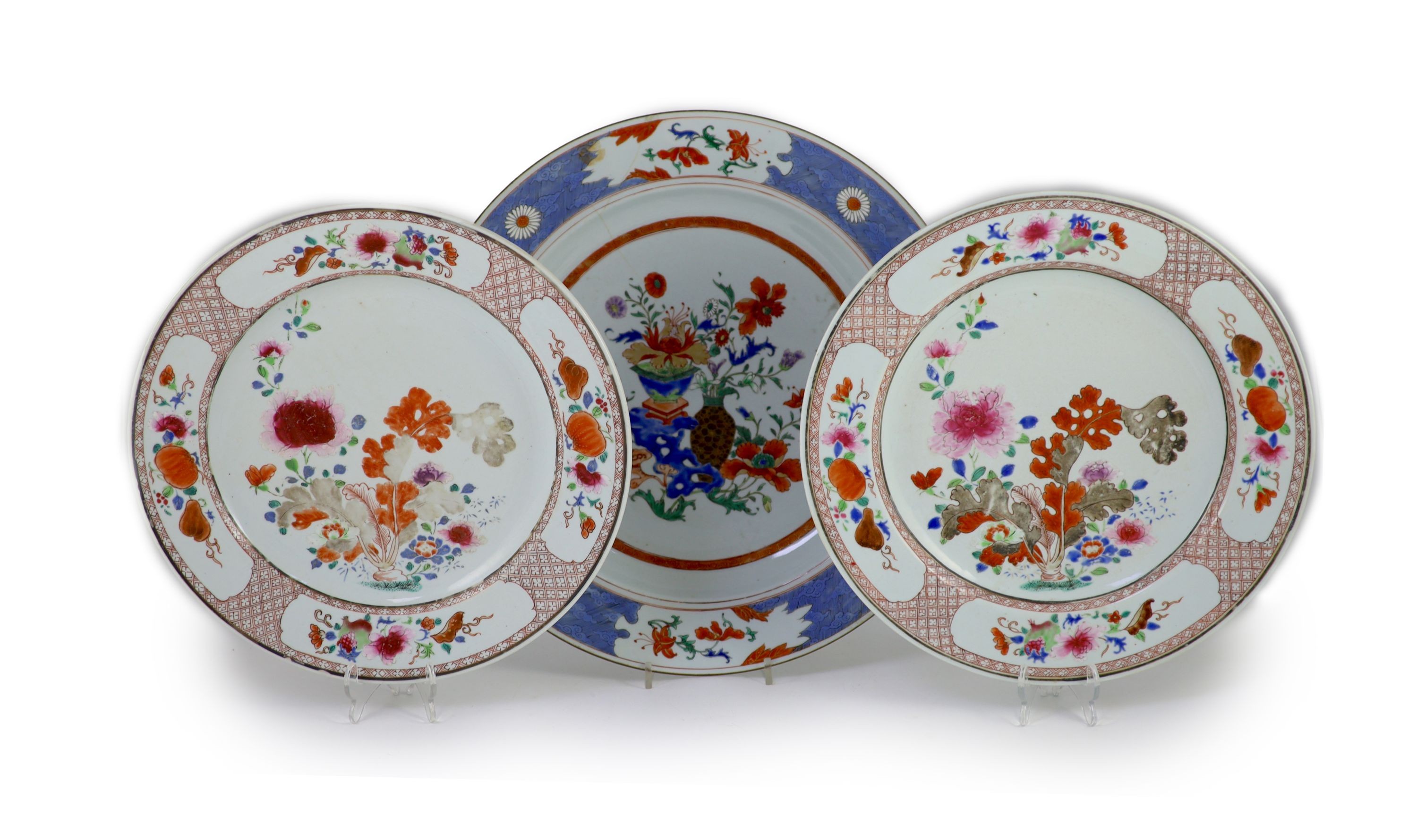 A pair of Chinese export famille rose dishes and a similar charger, early Qianlong period, diameter 35 cm and 42 cm, the charger broken and repaired                                                                        