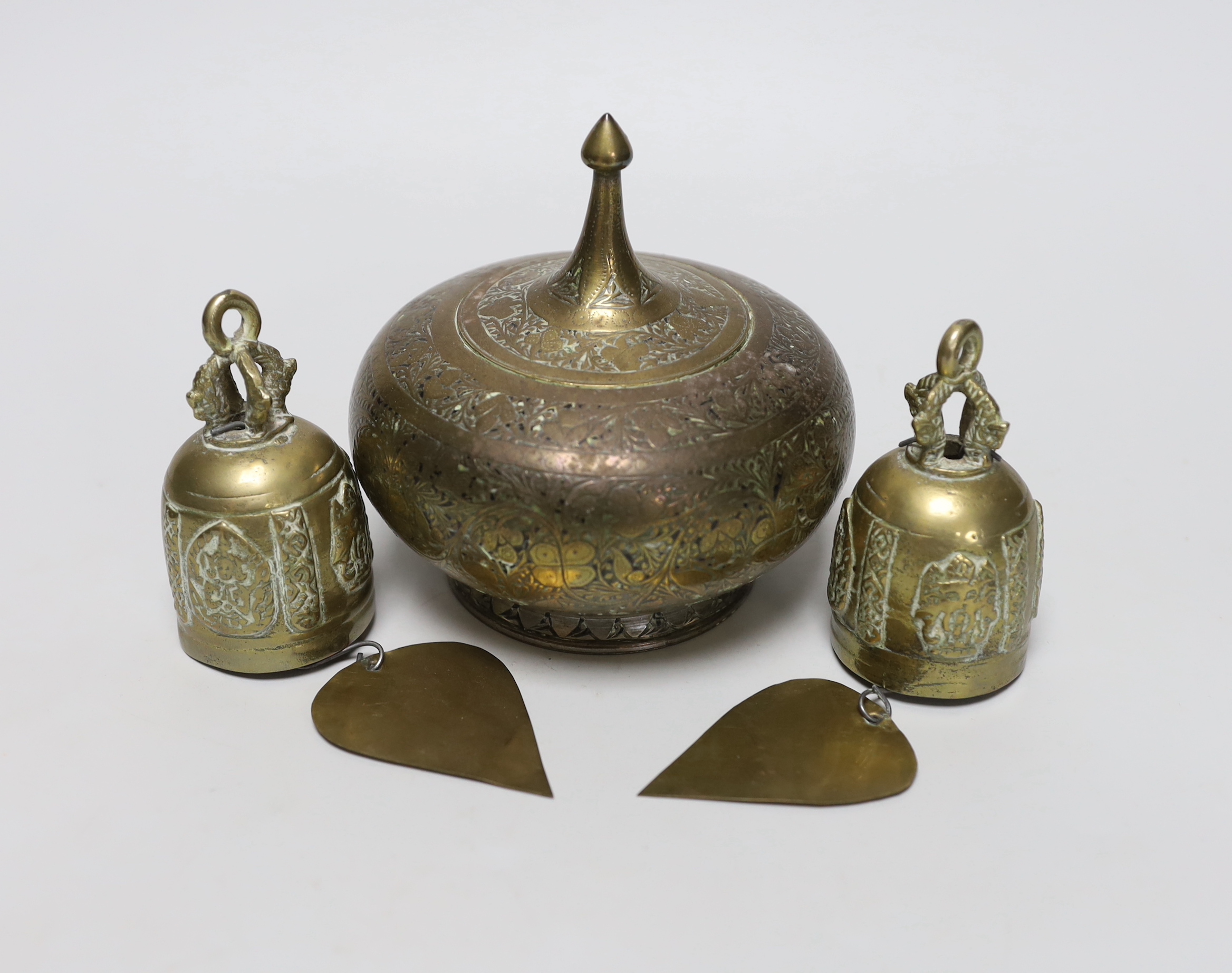 A pair of Eastern brass bells and lidded jar, largest 12cm high                                                                                                                                                             