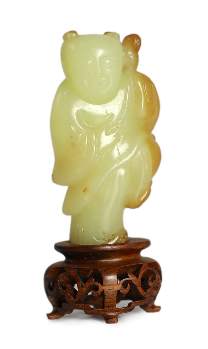 A rare Chinese yellow and russet jade figure of a boy holding a parrot, 18th/19th century, 5.6cm high, wood stand                                                                                                           