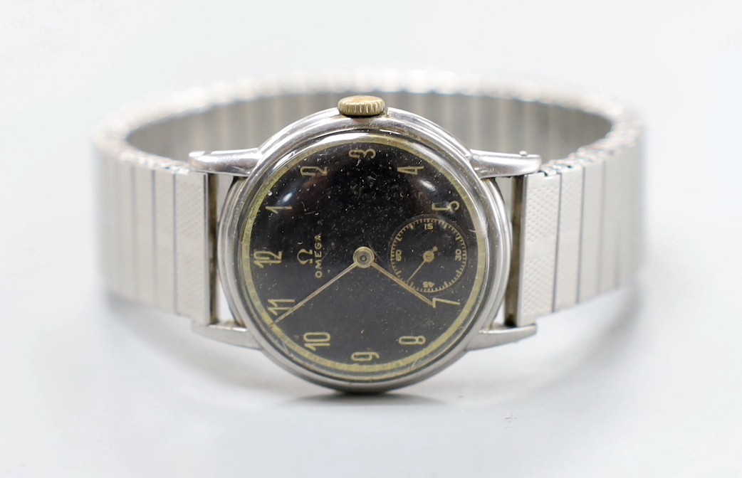 A gentleman's stainless steel Omega manual wind wrist watch, case diameter 29mm, with black Arabic dial and subsidiary seconds, on associated flexible strap.                                                               