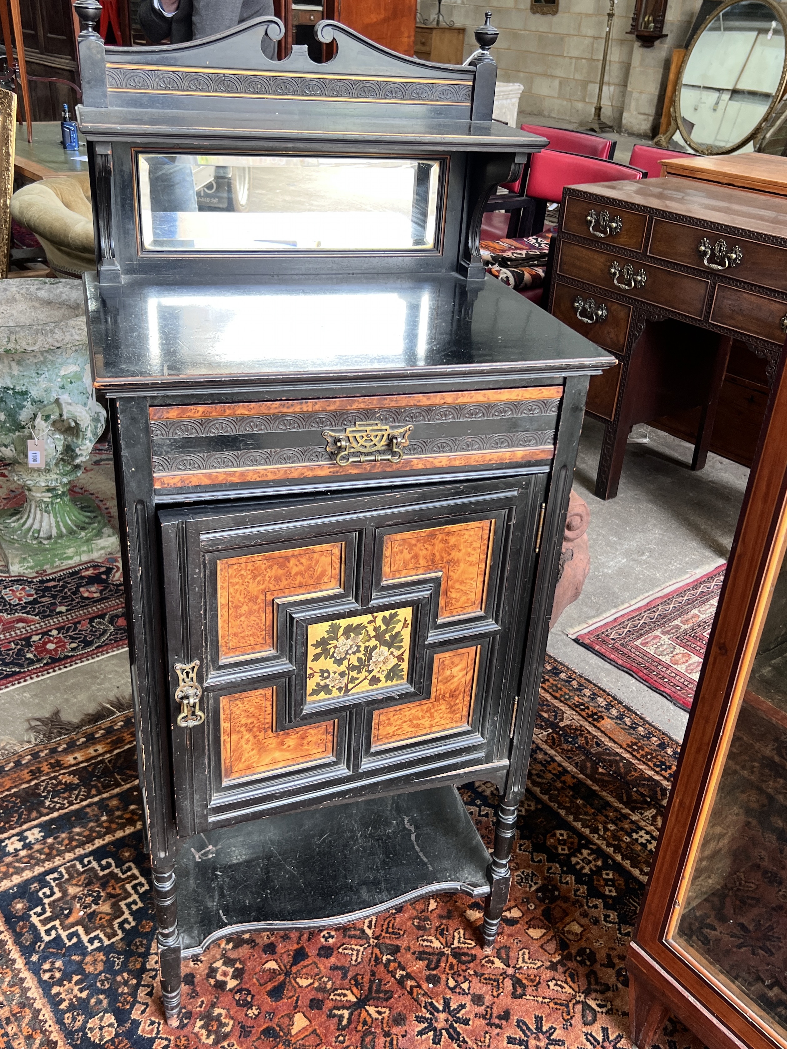 A late Victorian aesthetic movement ebonised amboyna side cabinet, width 55cm, depth 40cm, height 131cm                                                                                                                     