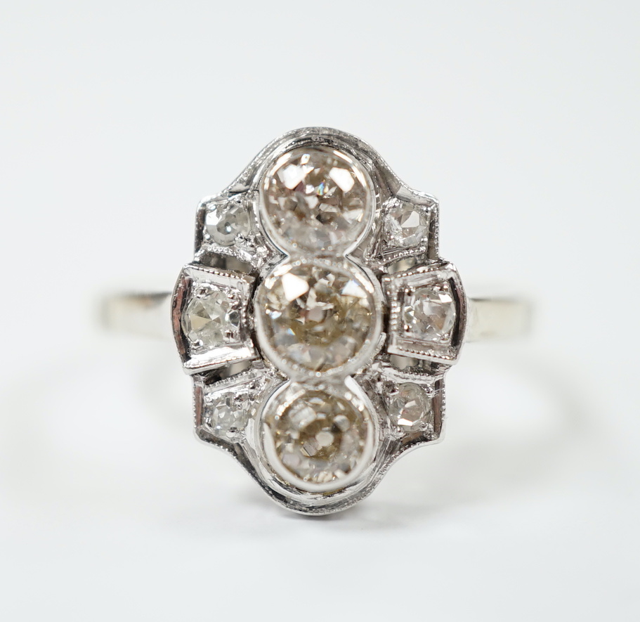 An Art Deco pierced white metal and millegrain set diamond cluster ring, size L, gross weight 3.2 grams.                                                                                                                    