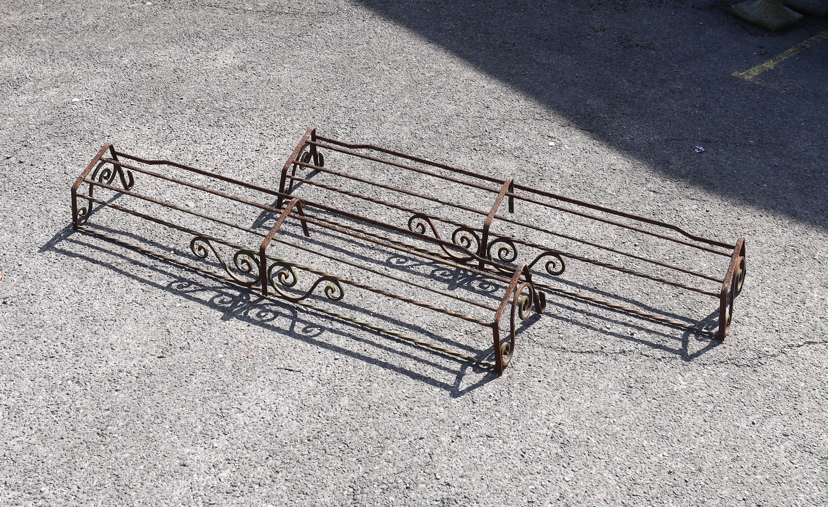 Three wrought iron pot stands and hangers, largest width 140cm                                                                                                                                                              