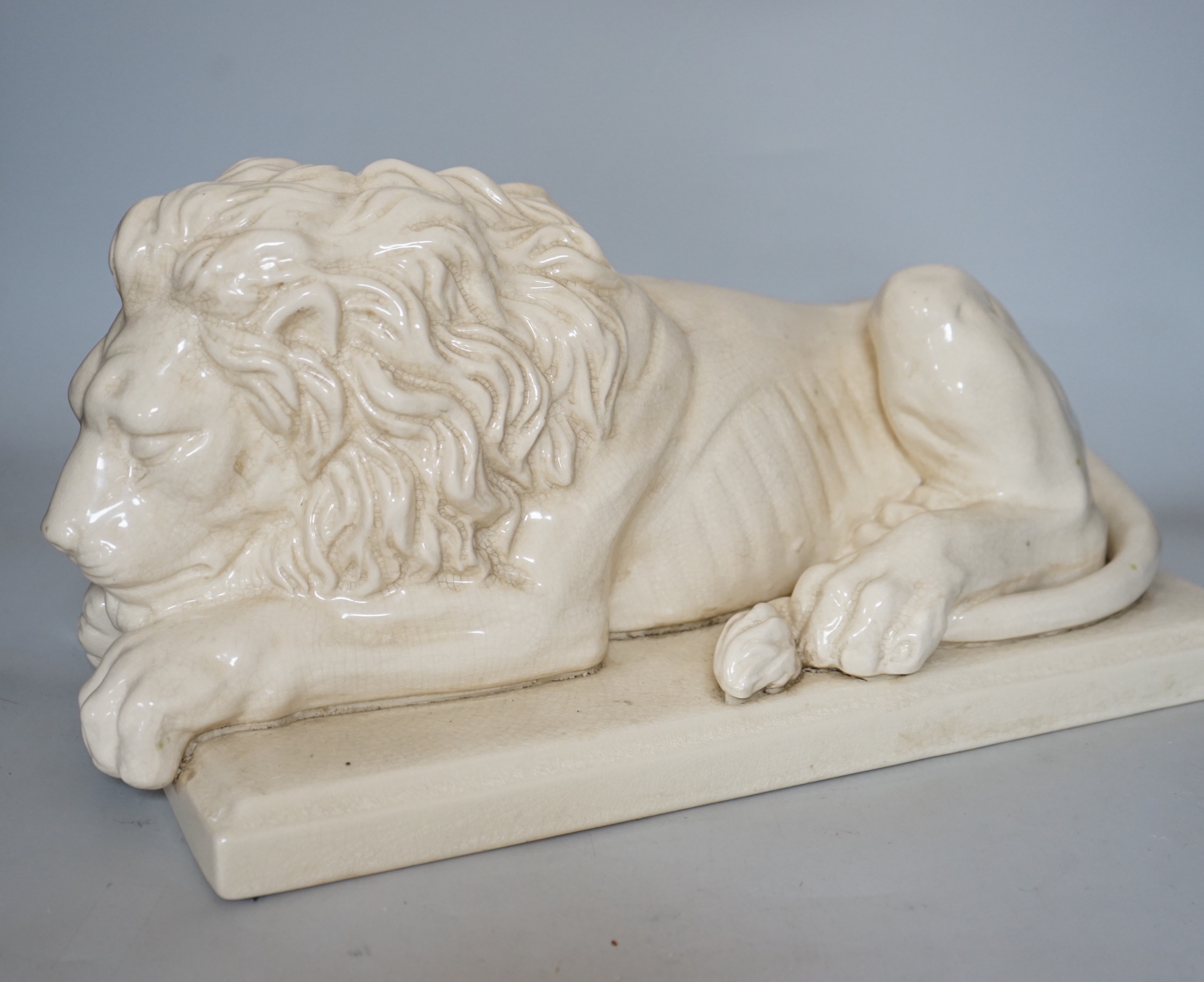 After Canova, a French cream crackleware pottery recumbent lion, 46cm wide                                                                                                                                                  