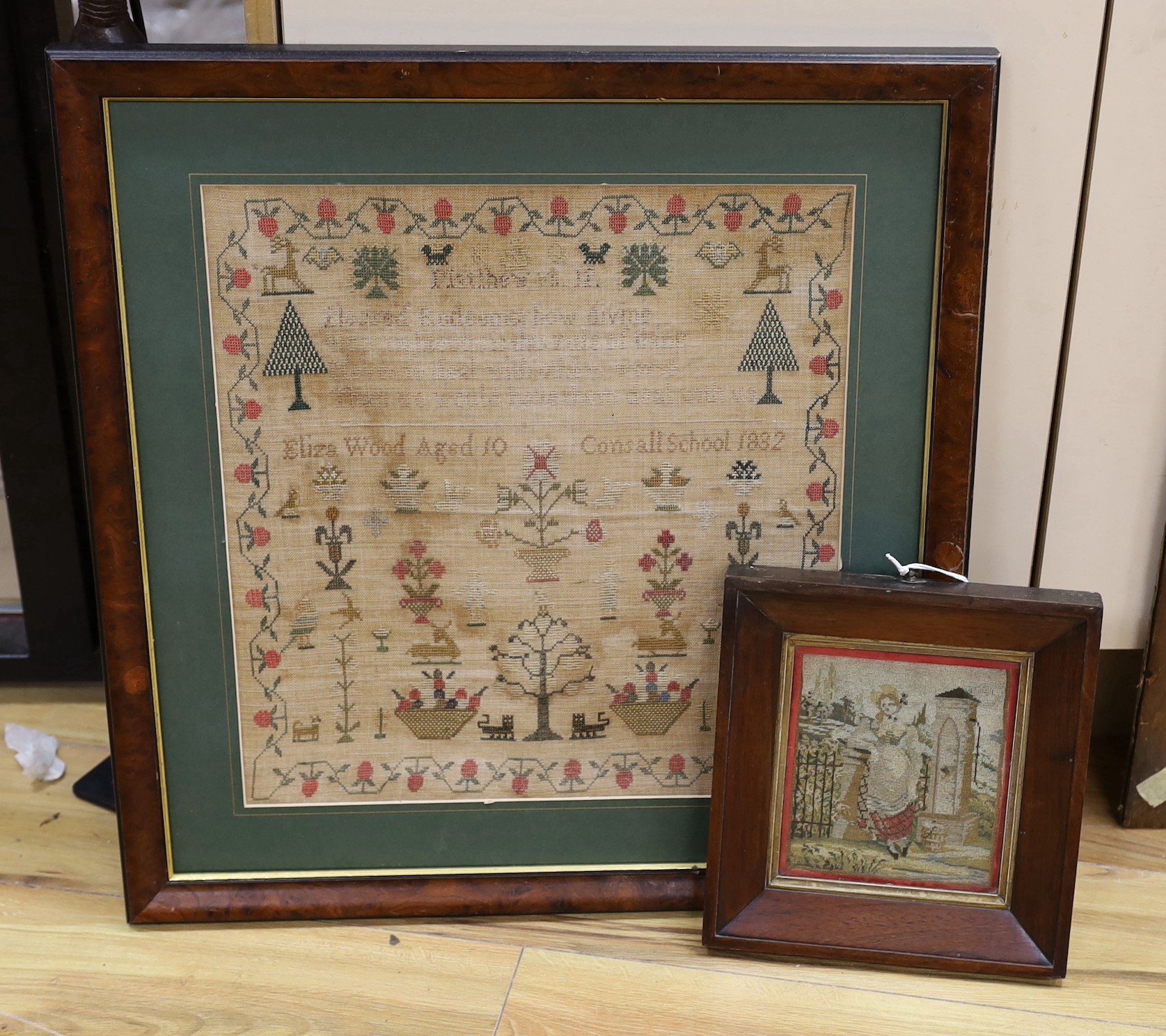 A late 19th century sample by Eliza Wood, aged 10, dated 1882, 43 x 40cm, together with a smaller glazed frame needlework panel of a lady leaning                                                                           
